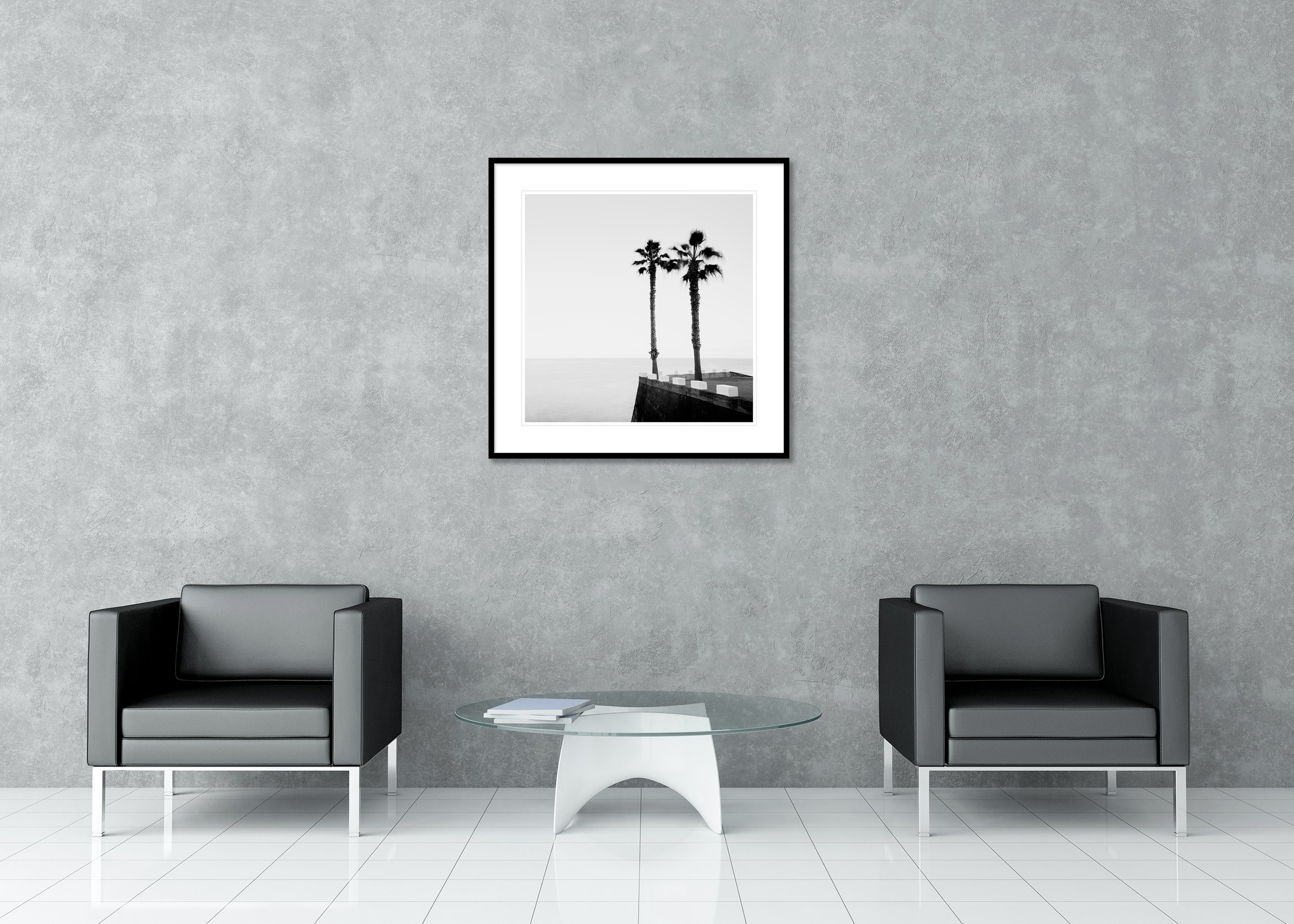 Parking Lot with Palm Trees displayed in a modern interior as an archival pigment print in a black aluminium frame with a white mount by Gerald Berghammer.
