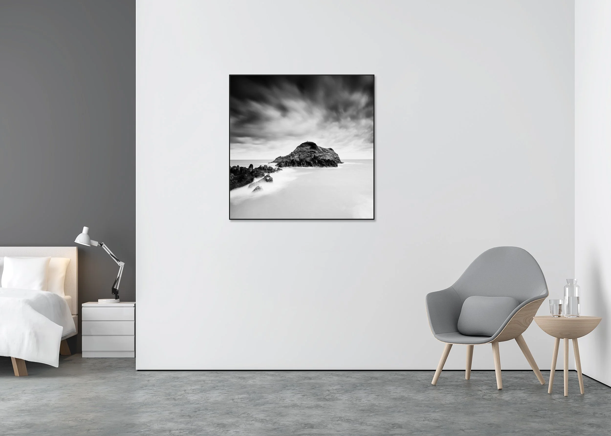 Black-and-white long-exposure seascape of a rocky island beneath dramatic clouds, ChromaLuxe metal print in an aluminium ArtBox frame.