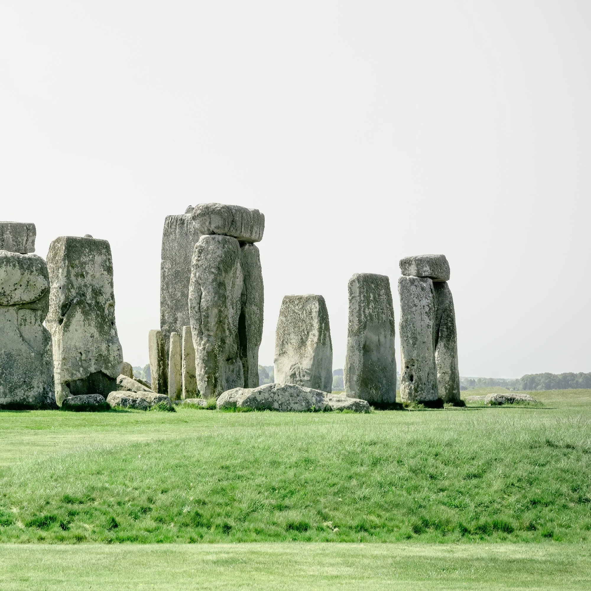 Gerald Berghammer - Color landscape panorama photography. Historic Stonehenge monument with large standing stones on a grassy field under a gray sky. Print detail 2