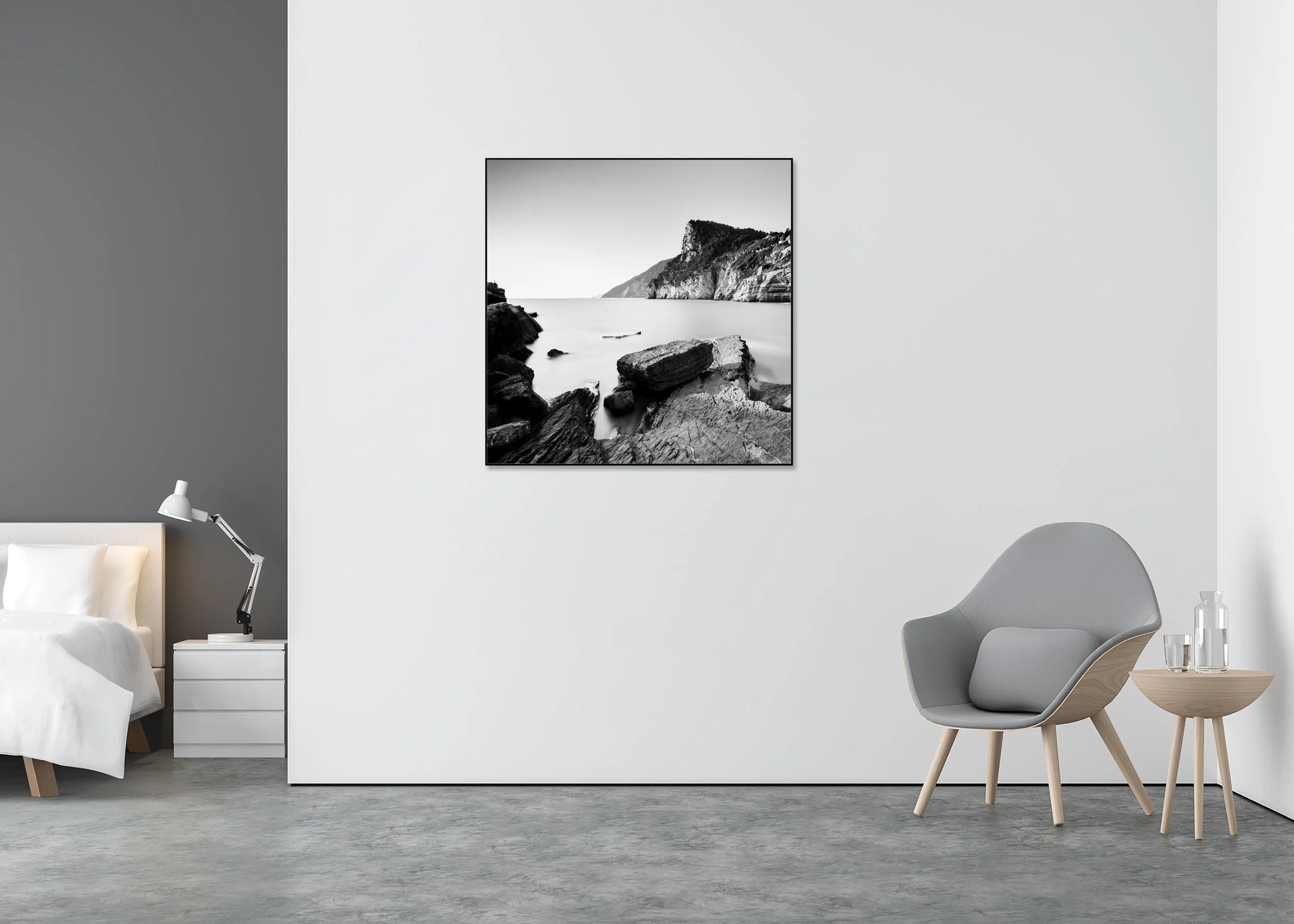 The Rocky Coast of Porto Venere – black-and-white photograph in a black aluminium ArtBox displayed in a minimalist bedroom.