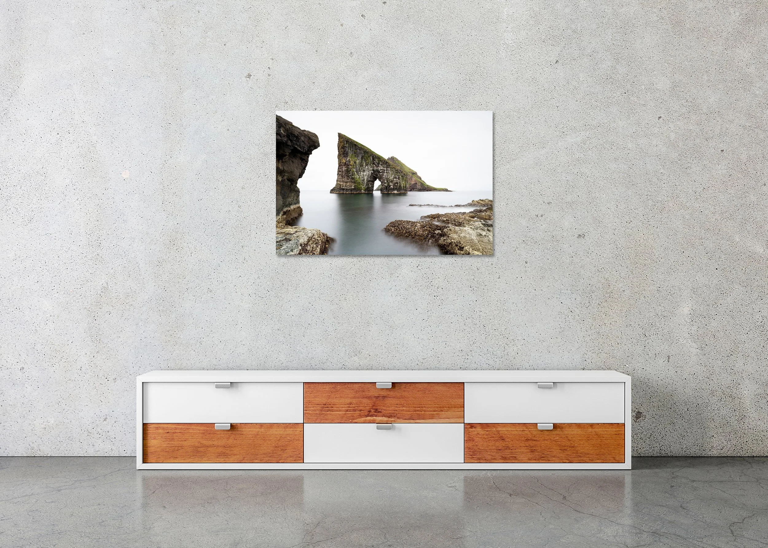 Drangarnir Sea Arch, Study 1 – frameless colour photograph on aluminium Dibond displayed above a low cabinet.