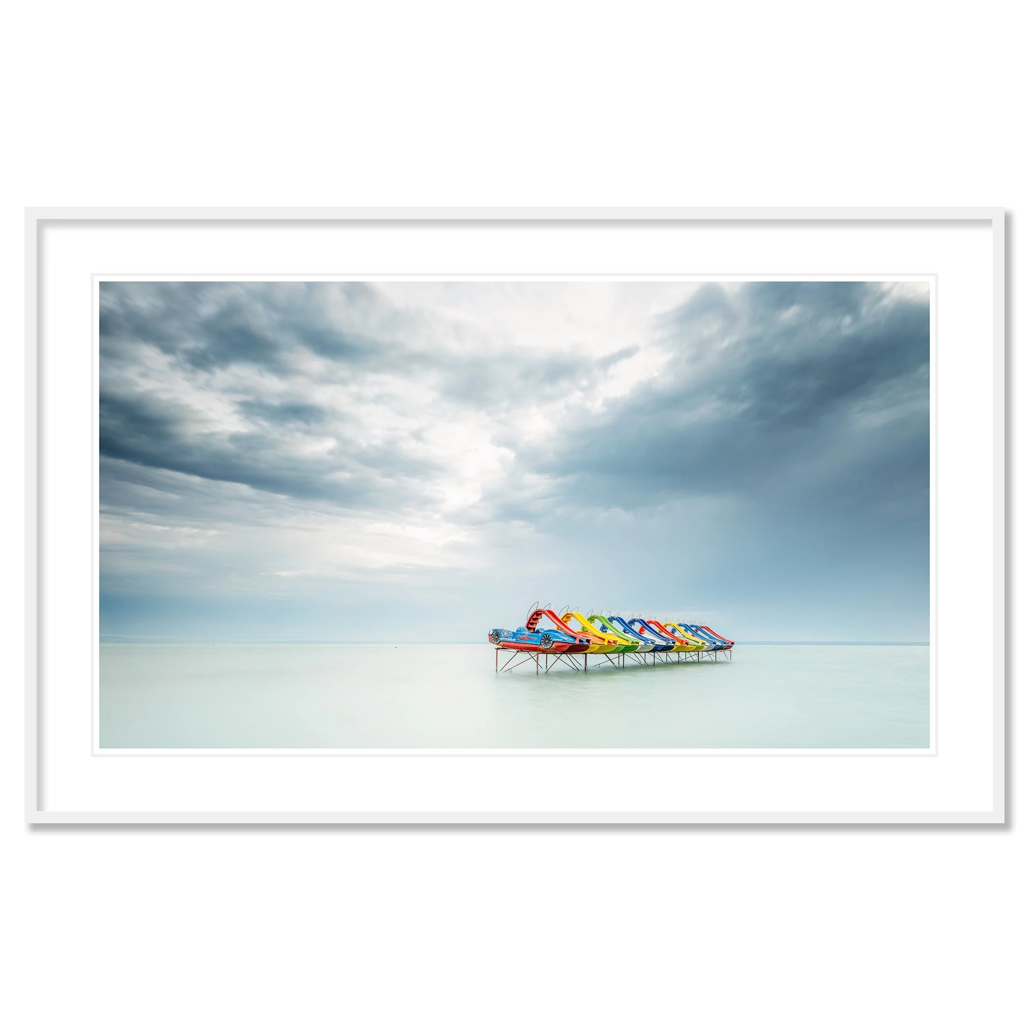 © 2021 Gerald Berghammer - Color panorama waterscape photography. A row of colorful pedal boats on the lake Balaton with dramatic cloudy sky. Classic framed white
