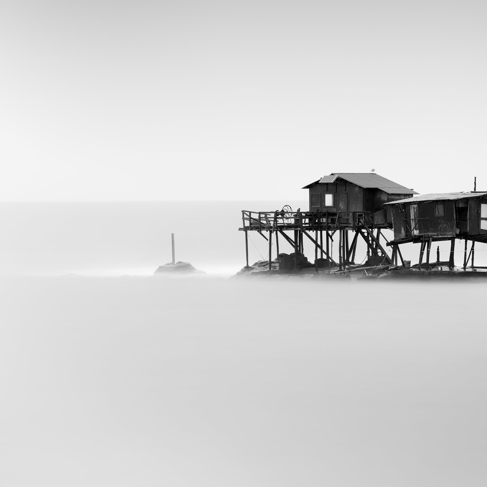 Detail of Marina di Pisa Study 1 showing the wooden stilt fishing huts above the long-exposure sea in Tuscany, Italy, by Gerald Berghammer.