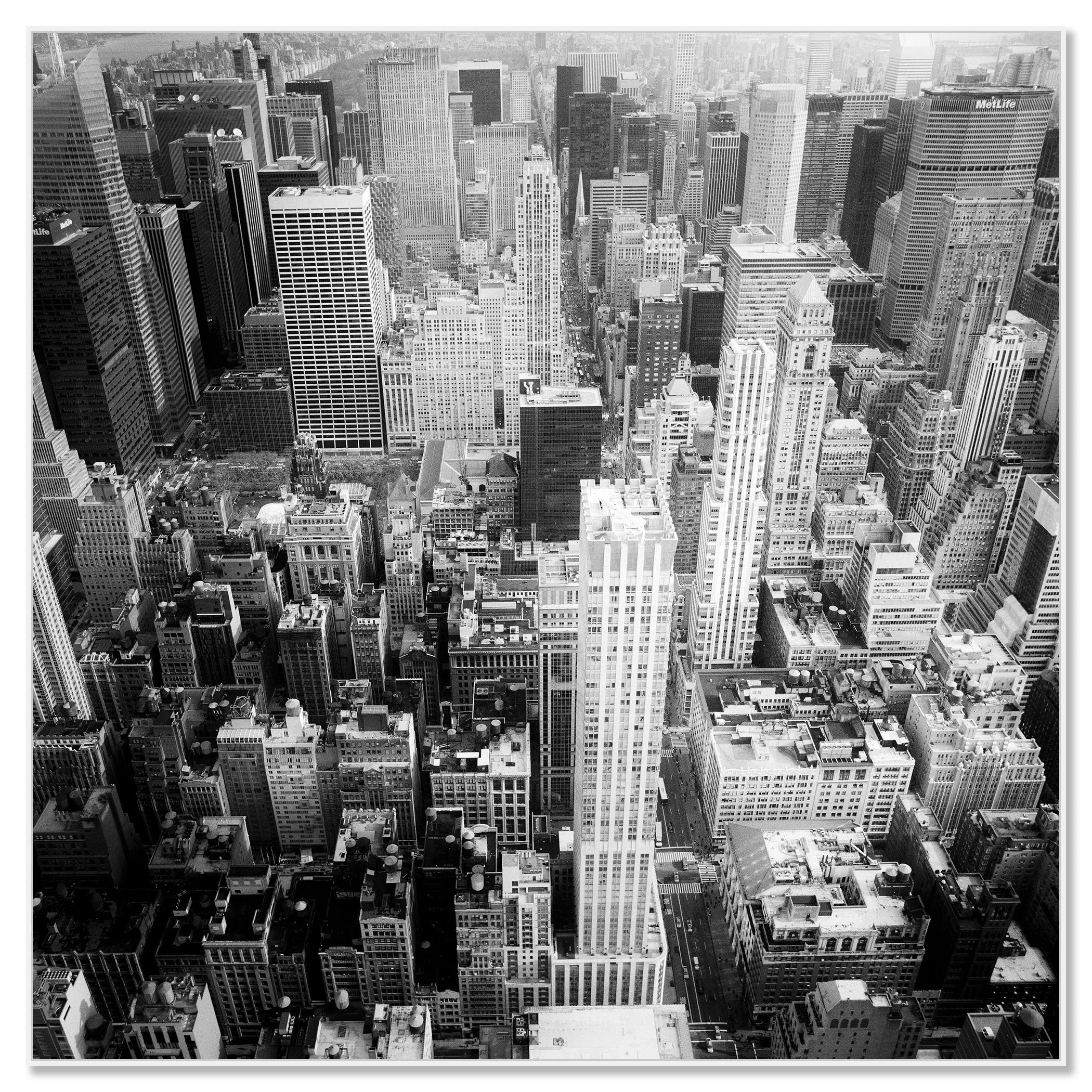 Black-and-white aerial view of New York City skyscrapers and dense urban streets, fine art cityscape photograph – framed ArtBox white