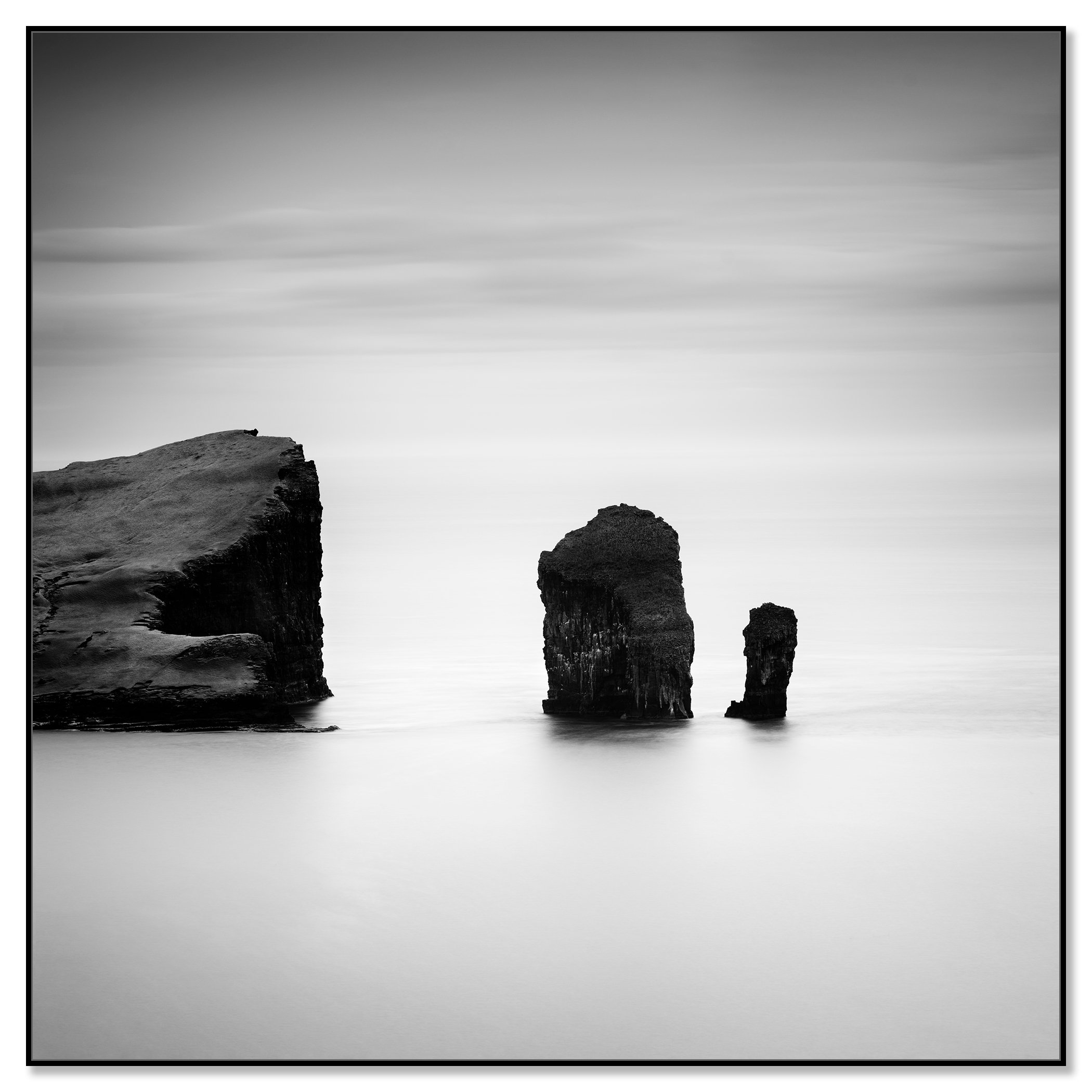 Black-and-white long exposure seascape with sea stacks off the coast of the Faroe Islands – framed ArtBox black