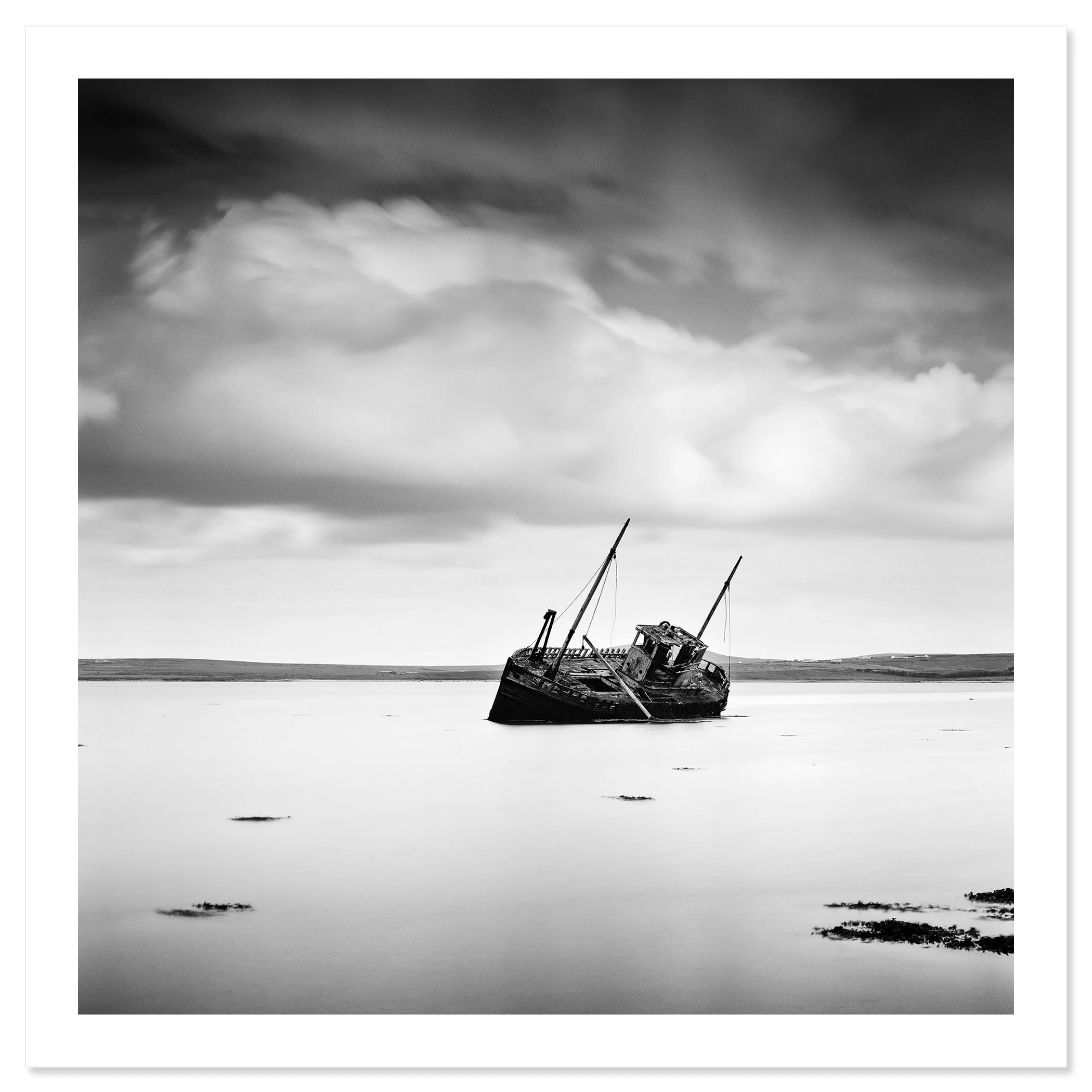 © 2014 Gerald Berghammer - Black and white minimalist seascape photography. An abandoned boat stuck in shallow water with cloudy sky overhead. Fine art print only