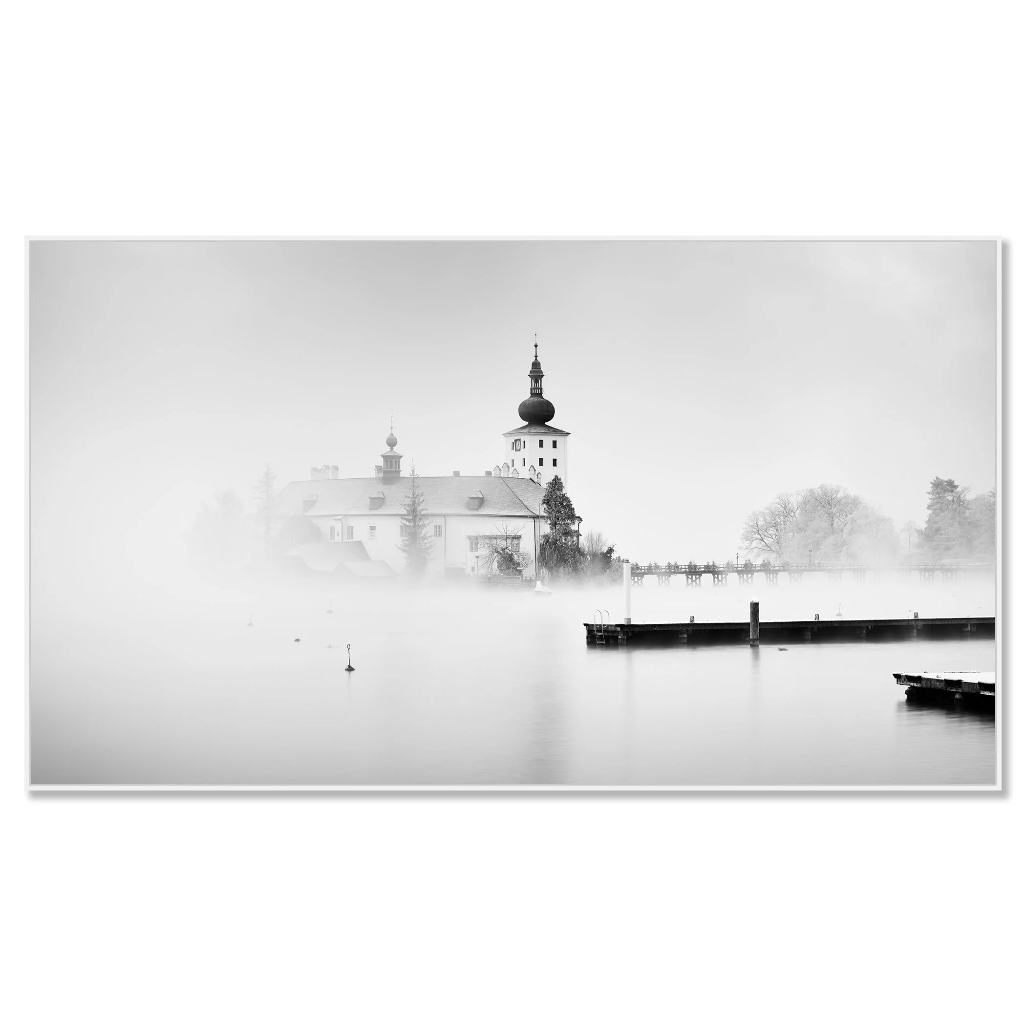 © 2022 Gerald Berghammer - Black and white cityscape photography. Schloss Ort - The historic church surrounded by mist over a lake with docks in the foreground. Chromaluxe framed white