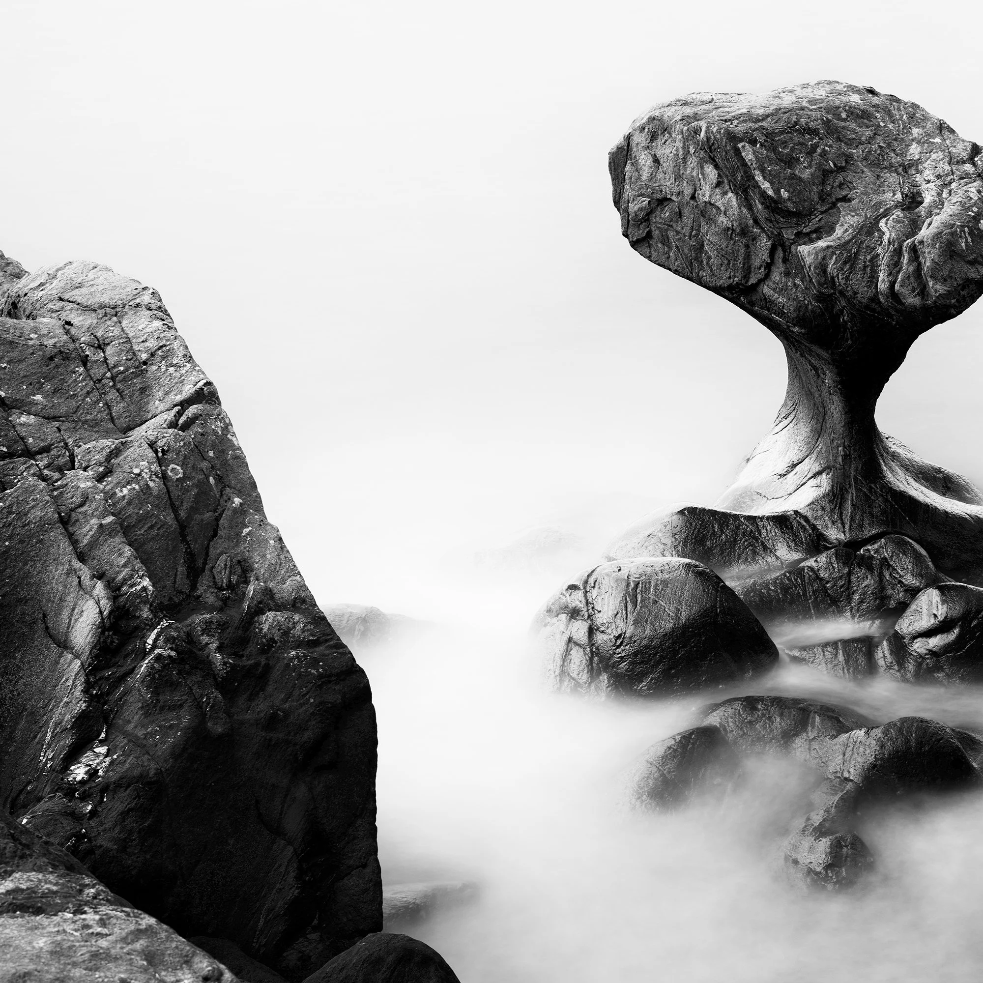 Attracted by the Sea Study 1 by Gerald Berghammer, detail showing rugged coastal rocks and mist-like long-exposure seawater.