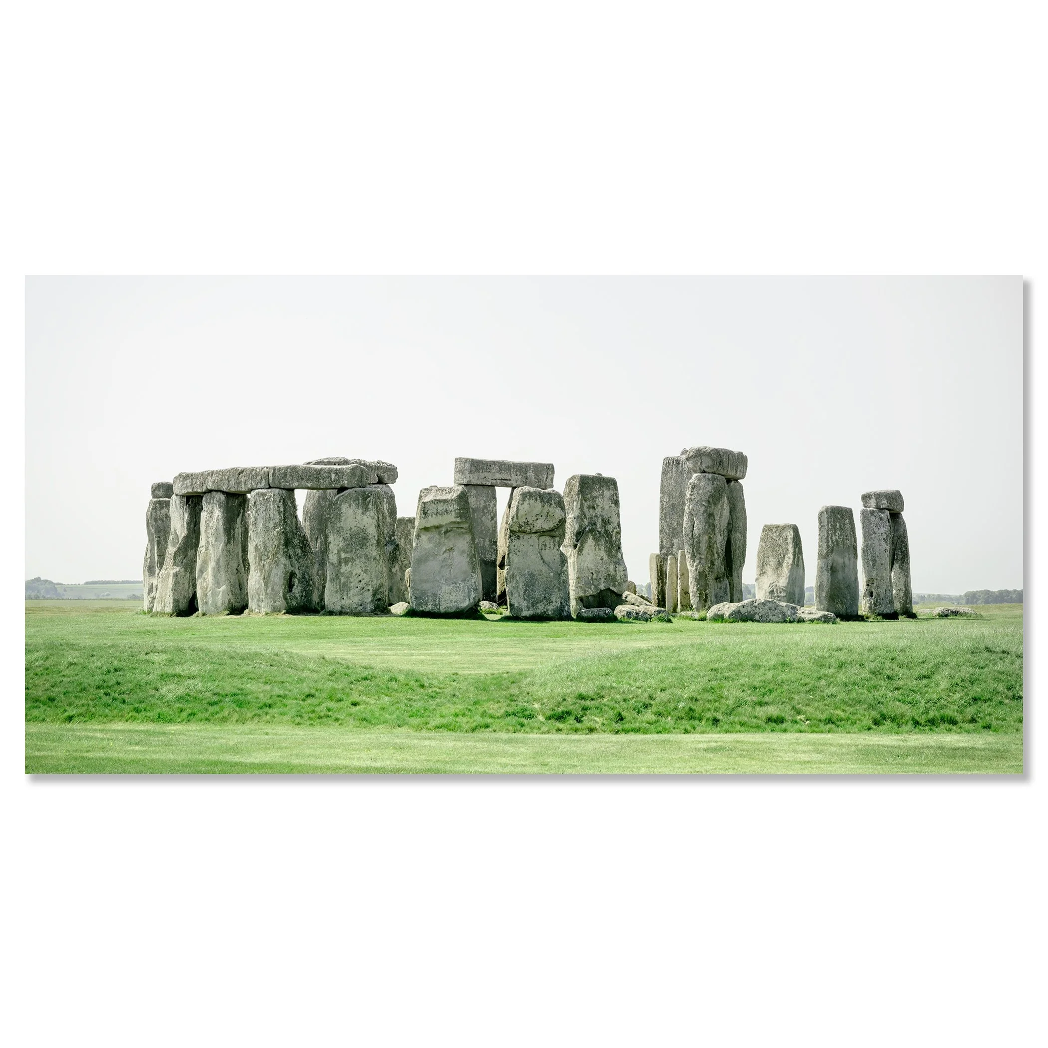 Gerald Berghammer - Color landscape panorama photography. Historic Stonehenge monument with large standing stones on a grassy field under a gray sky. Chromaluxe frameless
