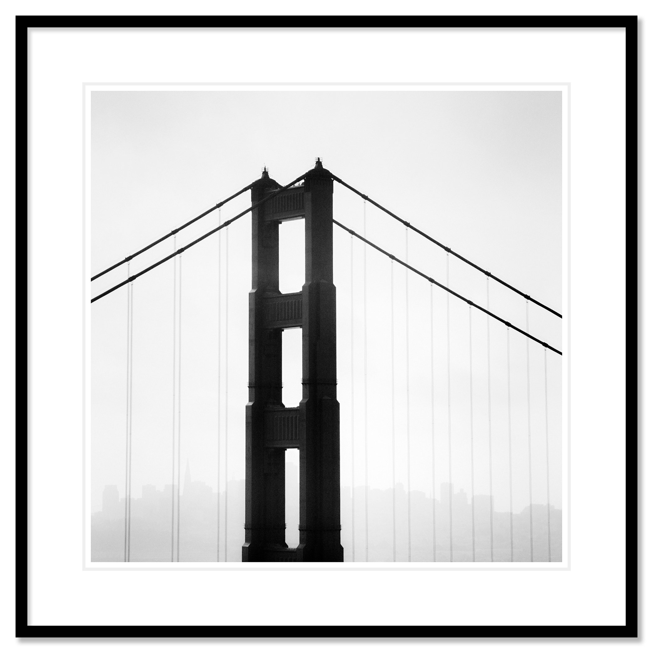 © 2015 Gerald Berghammer - Black and white photo. Golden Gate Bridge in San Francisco, seen from the side, with the city skyline faintly visible in the background. Classic framed black