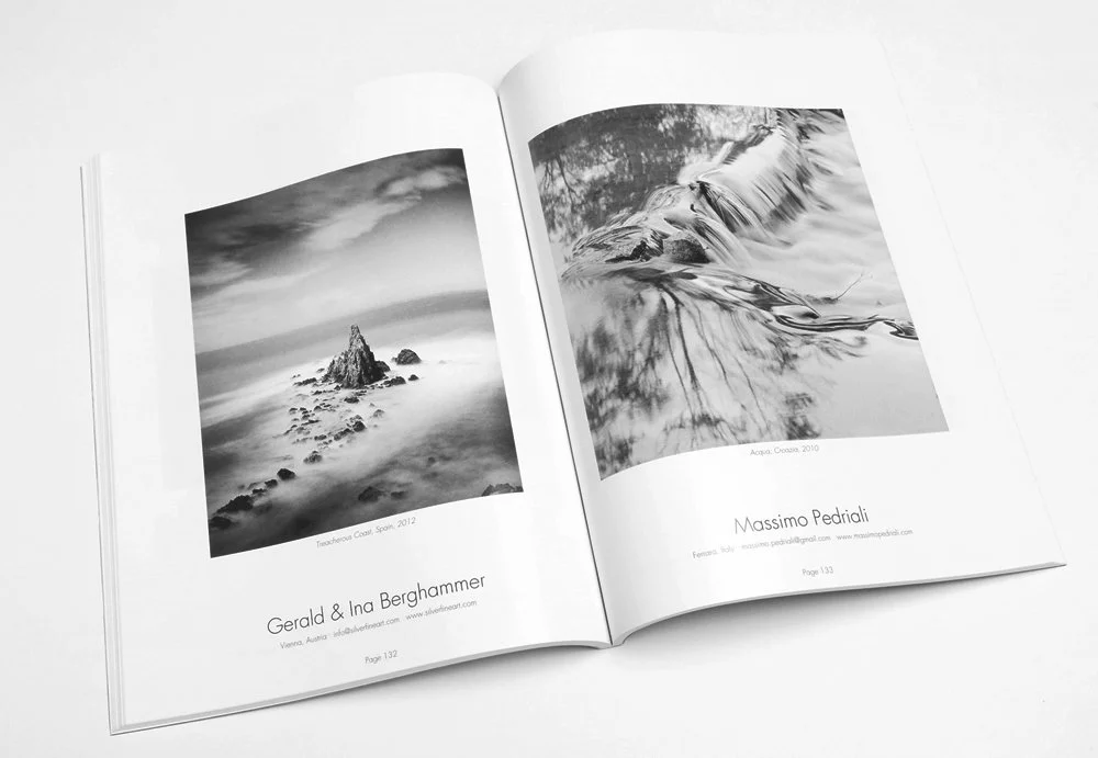 Open pages of Black & White Magazine's 2014 contest winners issue, featuring a published black-and-white coastal photograph by Gerald and Ina Berghammer.