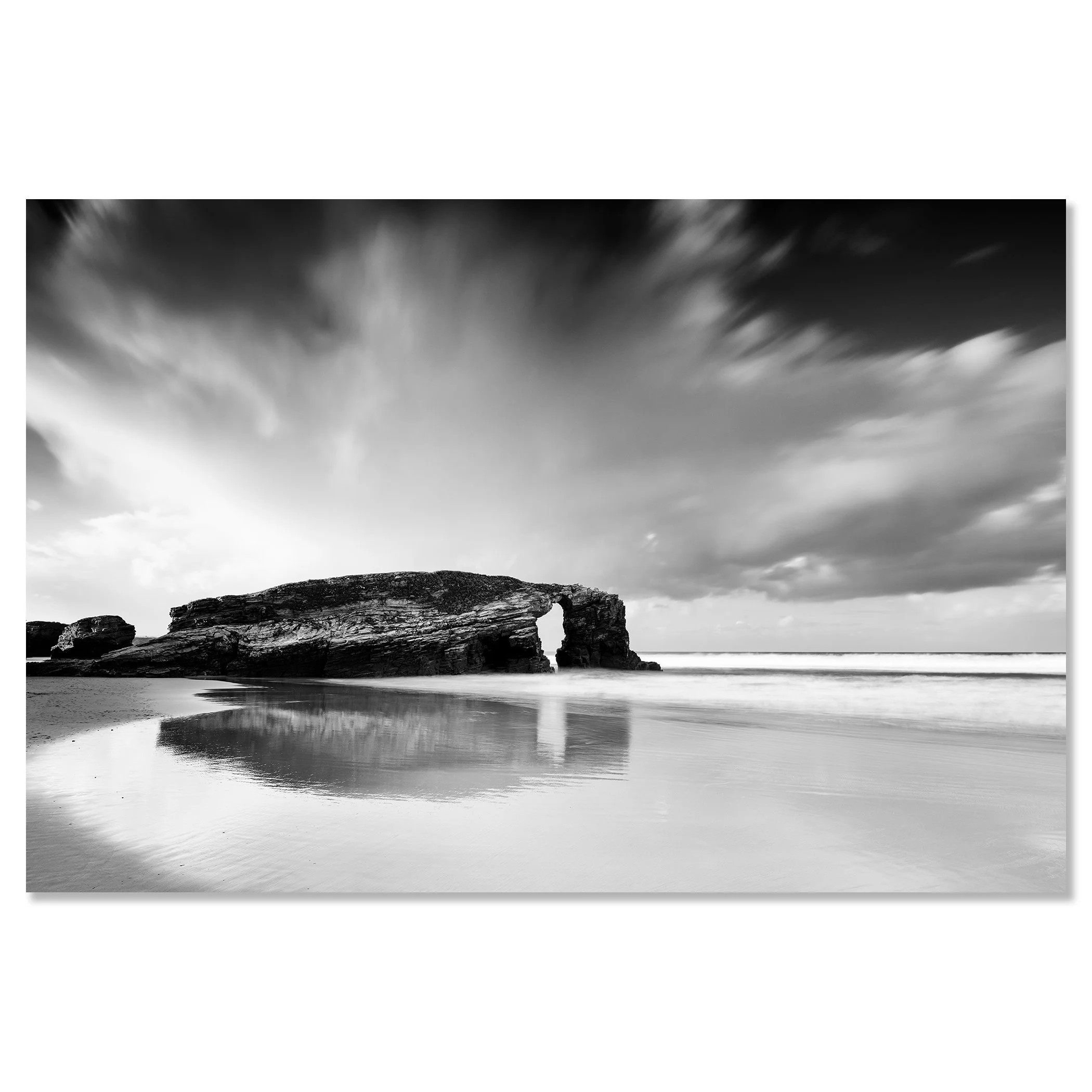 Black-and-white long-exposure seascape at As Catedrais Beach, Spain, with a natural rock arch and calm Atlantic water – dibond frameless