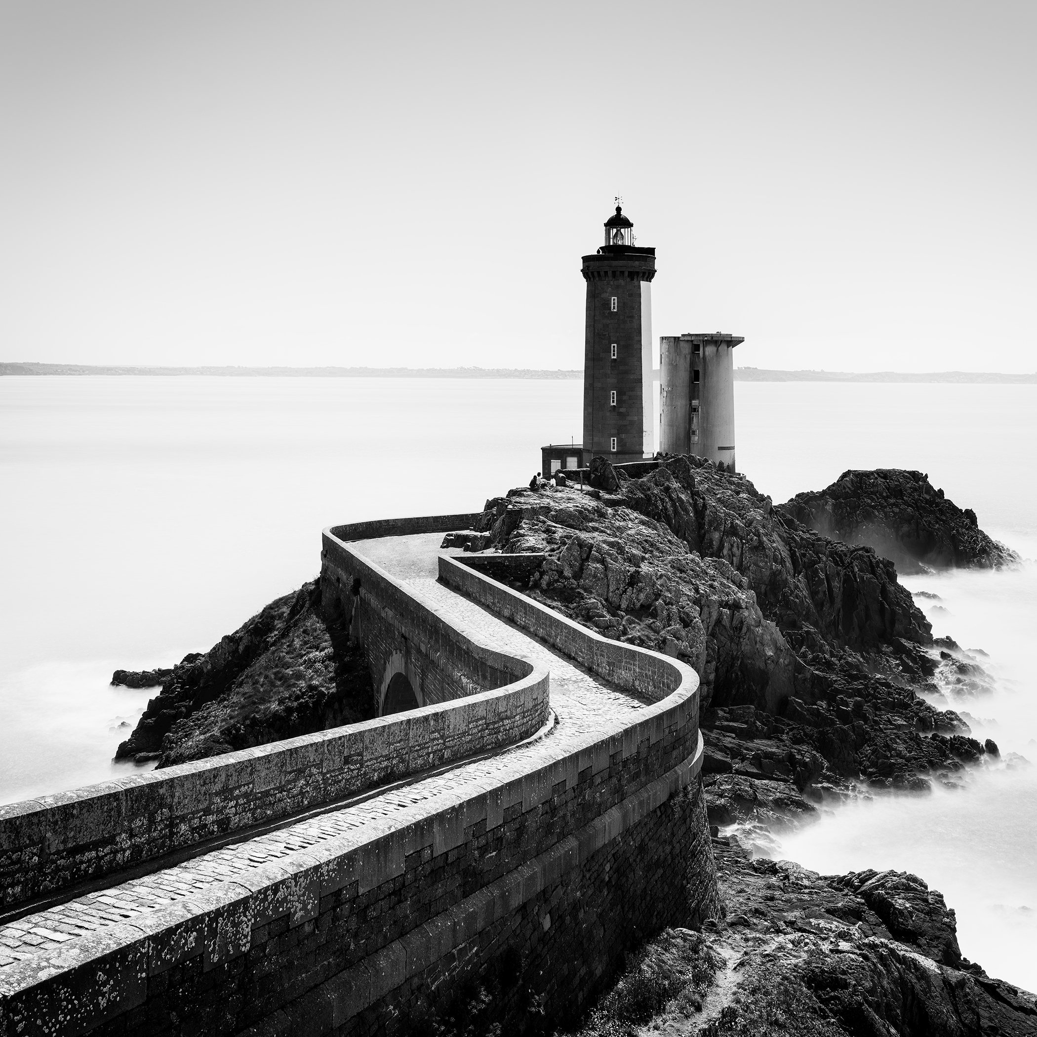 Atmospheric black-and-white long-exposure seascape of Petit Minou Lighthouse in Brittany, France, by Gerald Berghammer.