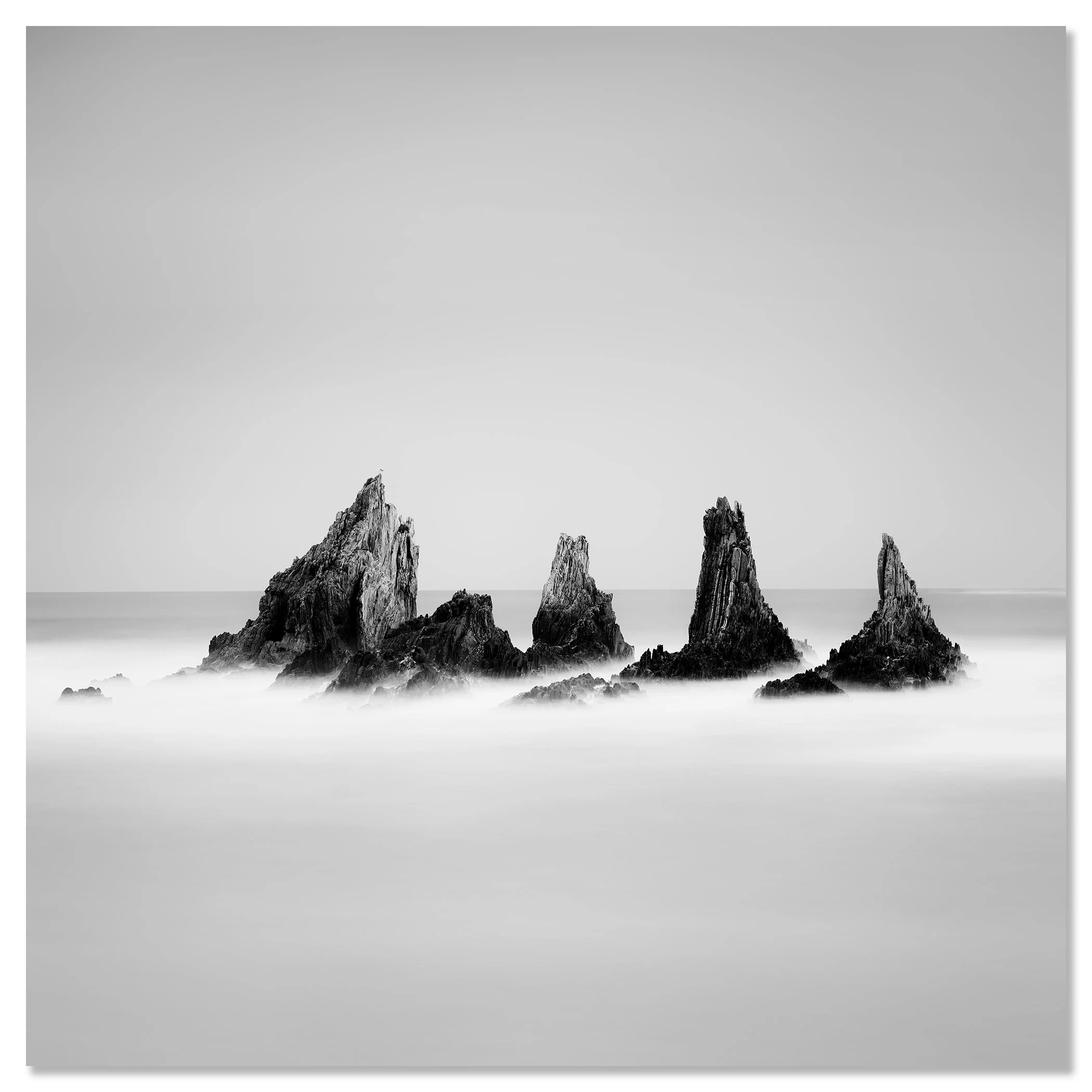 Rocky Peaks Study 1 by Gerald Berghammer, black-and-white seascape of sea stacks in Spain, mounted frameless on aluminium Dibond.