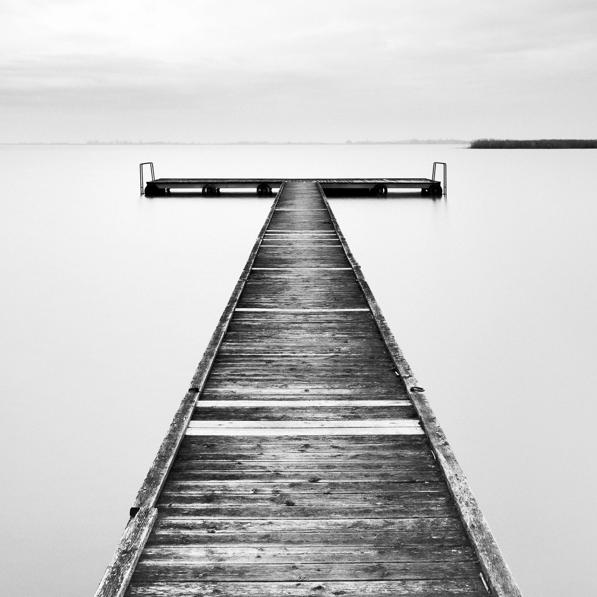 Detailed view of Winter Storm showing the wooden jetty beneath a dramatic long-exposure sky by Gerald Berghammer.