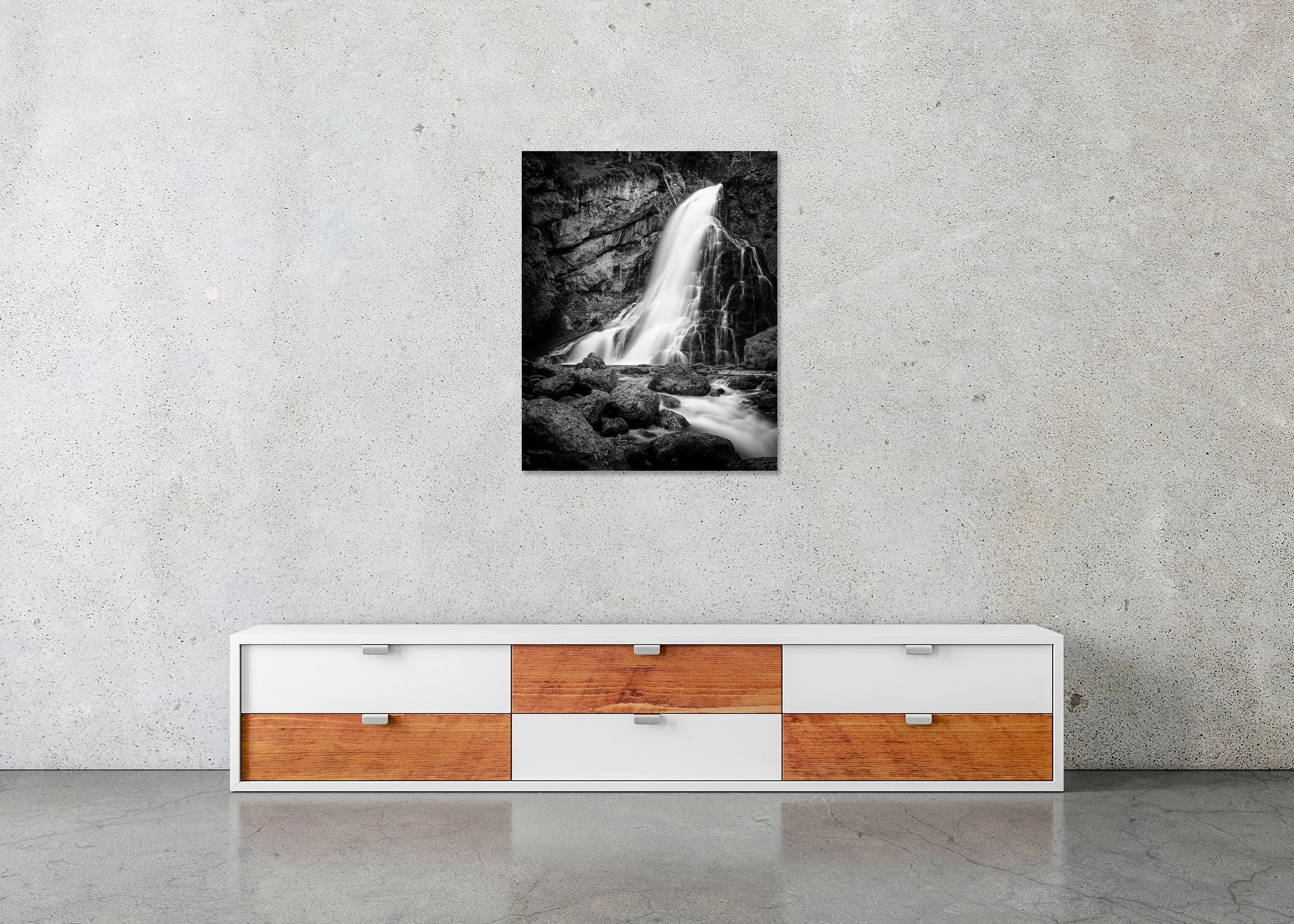 Golling Waterfall frameless Dibond print displayed above a low cabinet in a contemporary interior.
