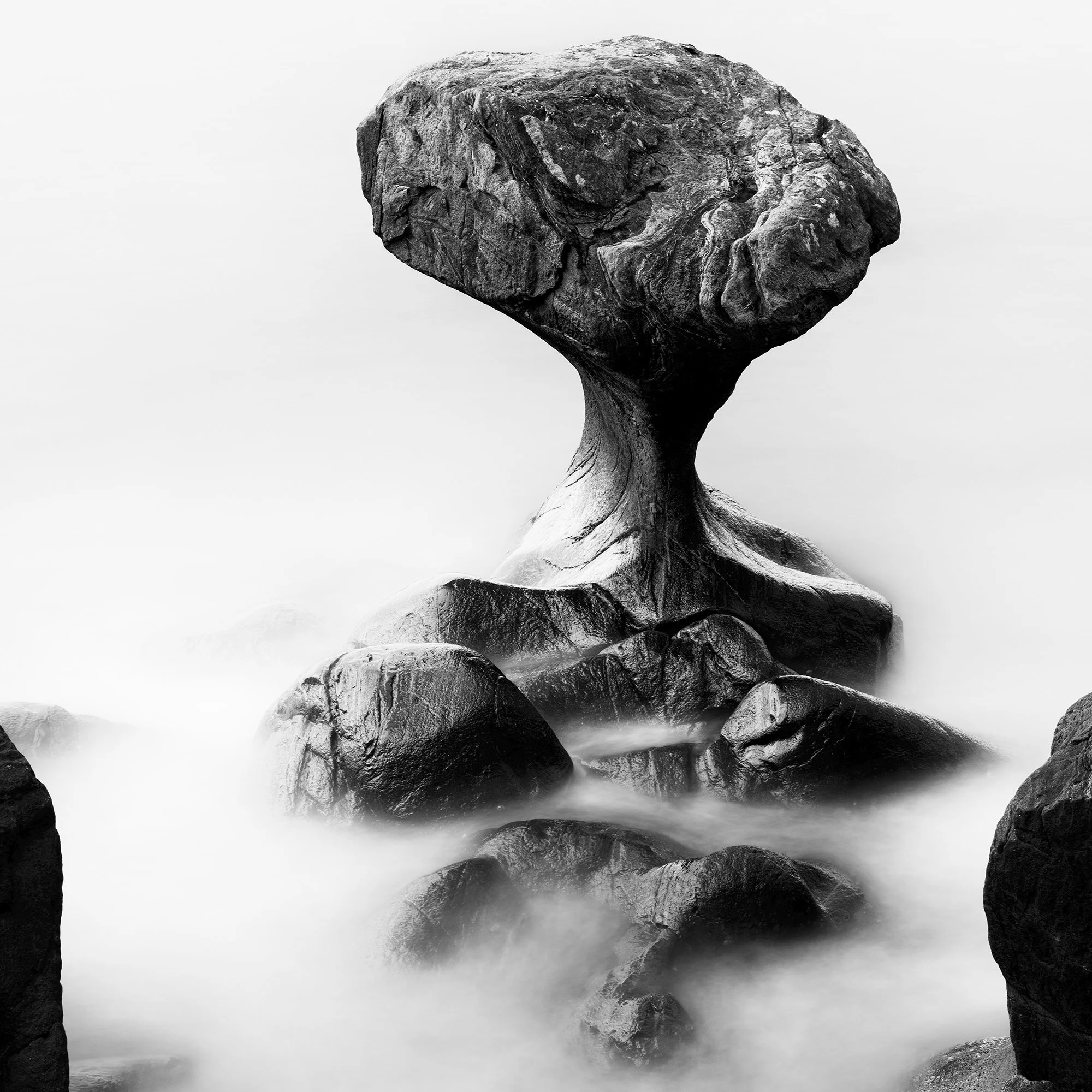 Attracted by the Sea Study 1 by Gerald Berghammer, close-up of the sculptural central rock surrounded by smooth seawater.