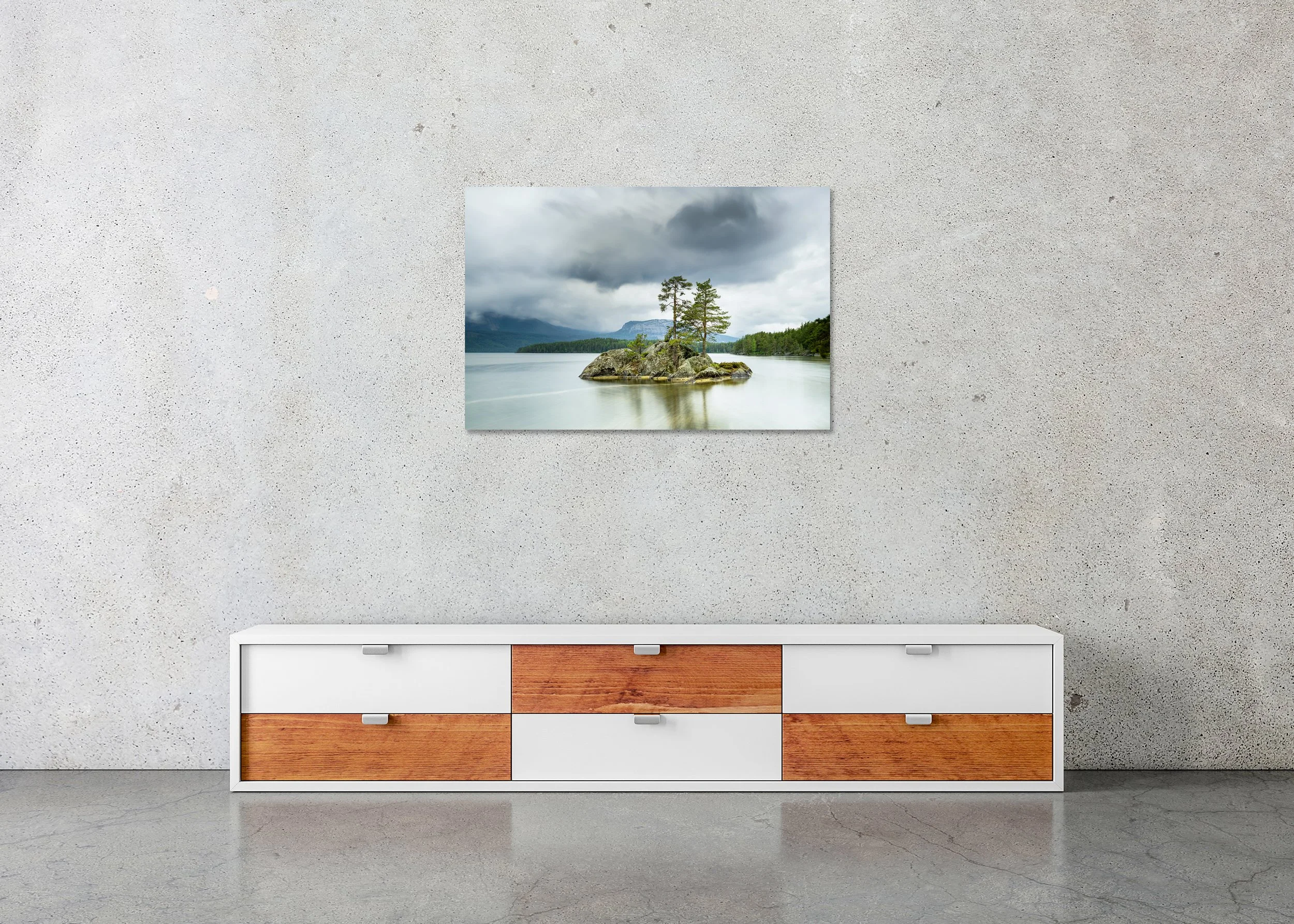Small Rocky Island with Trees, Norway, displayed in a modern interior as a frameless colour artwork mounted on aluminium Dibond by Gerald Berghammer.