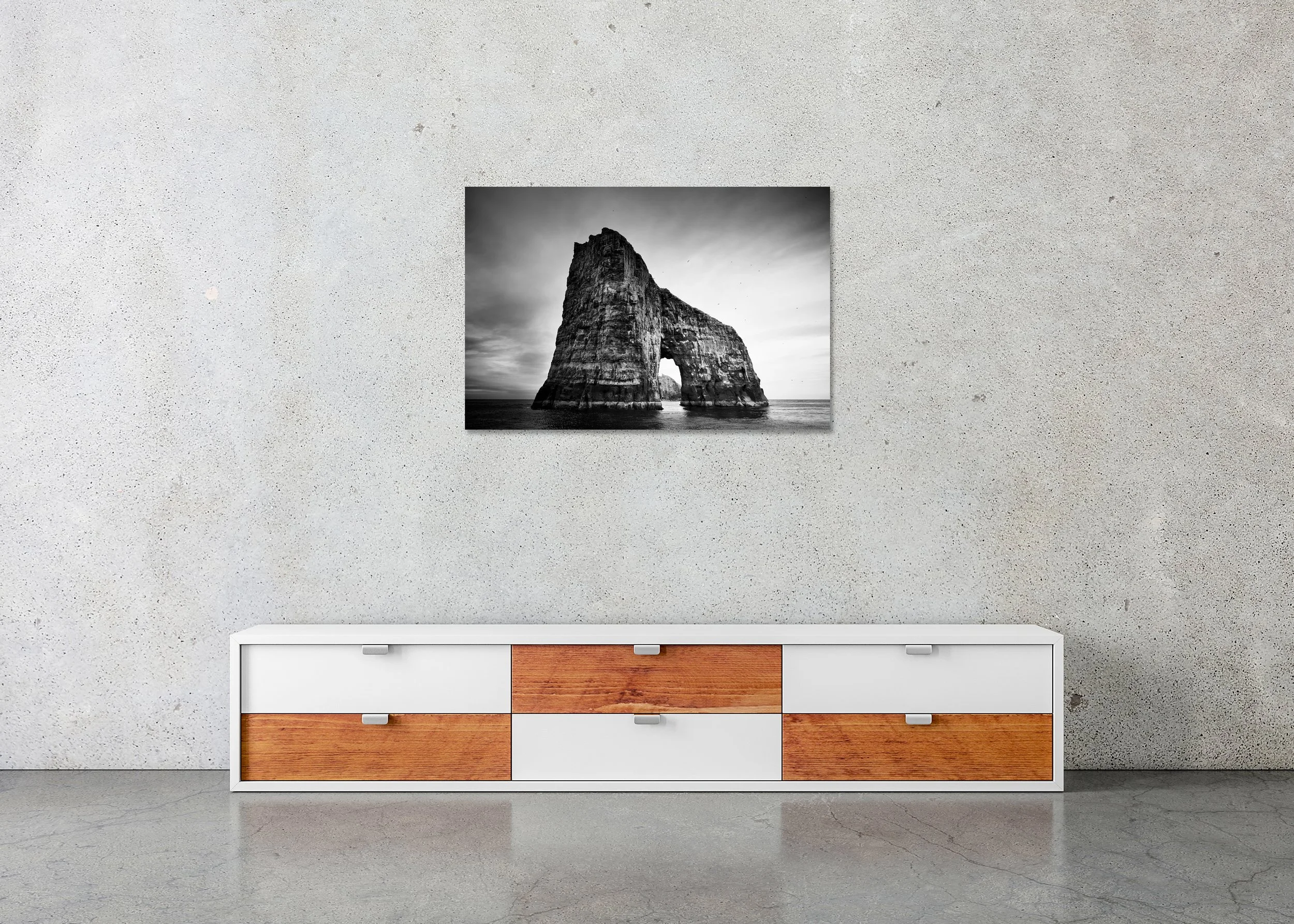 Monochrome seascape photo print of a dramatic rock arch rising from the ocean, mounted to Dibond, frameless