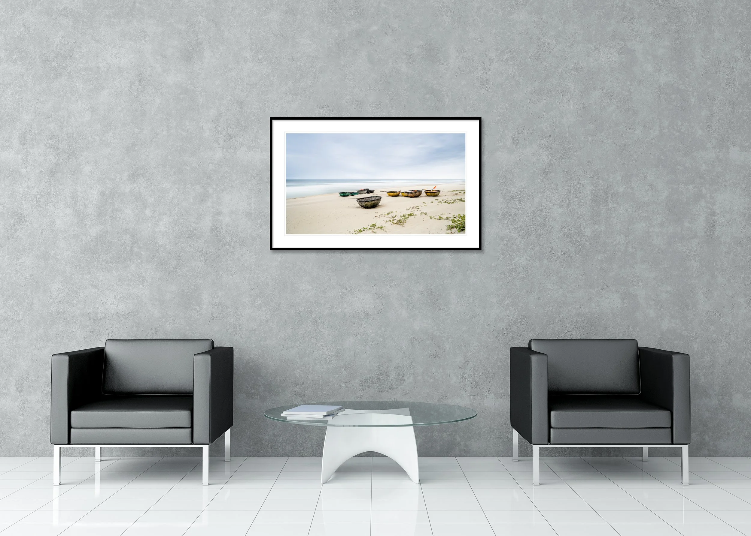 Traditional fishing boats on an empty beach beside a calm sea under a soft hazy sky, archival pigment print in a classic frame with mount.