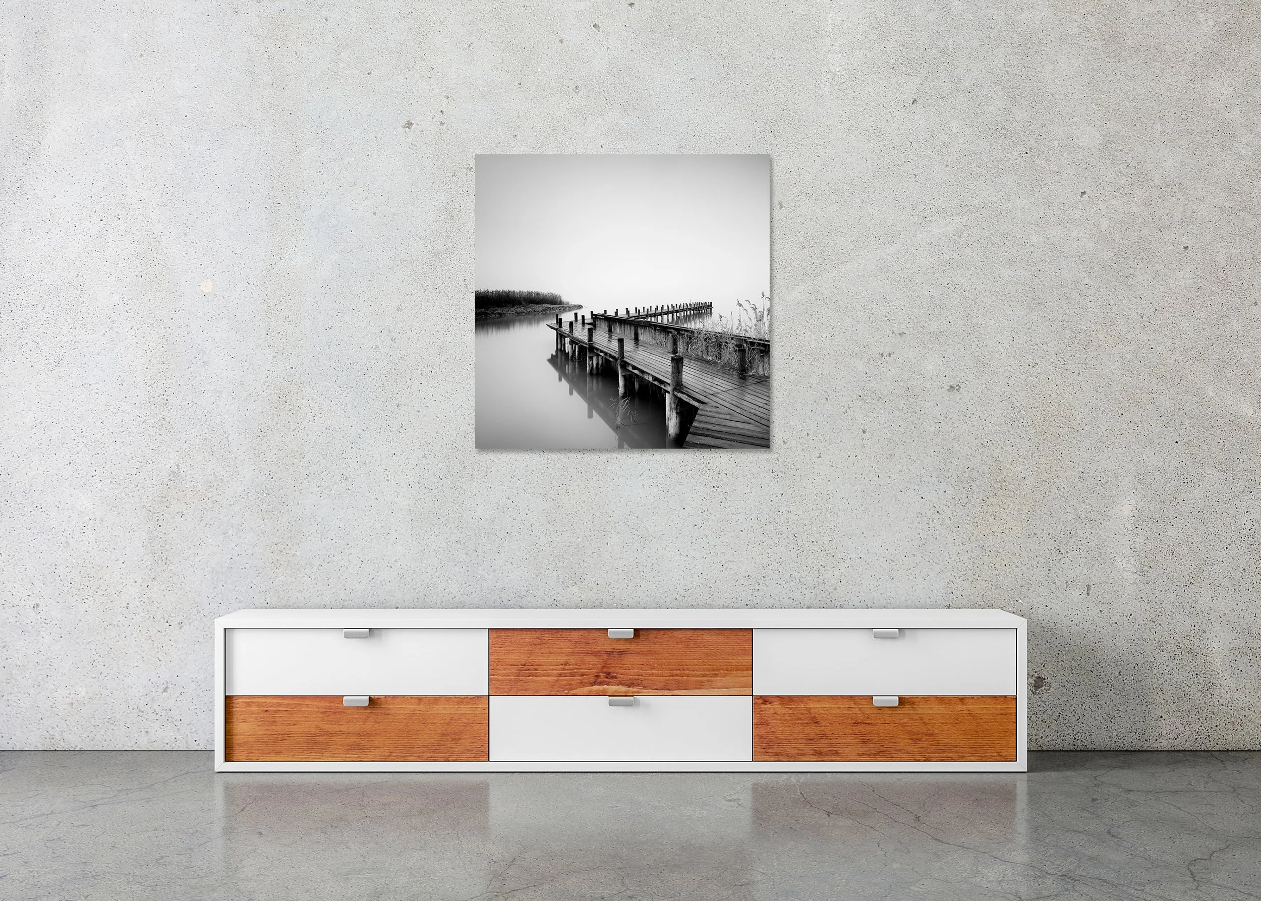 Black and white landscape photo print with a wooden jetty, calm reflective water and a soft misty horizon, mounted to Dibond, frameless