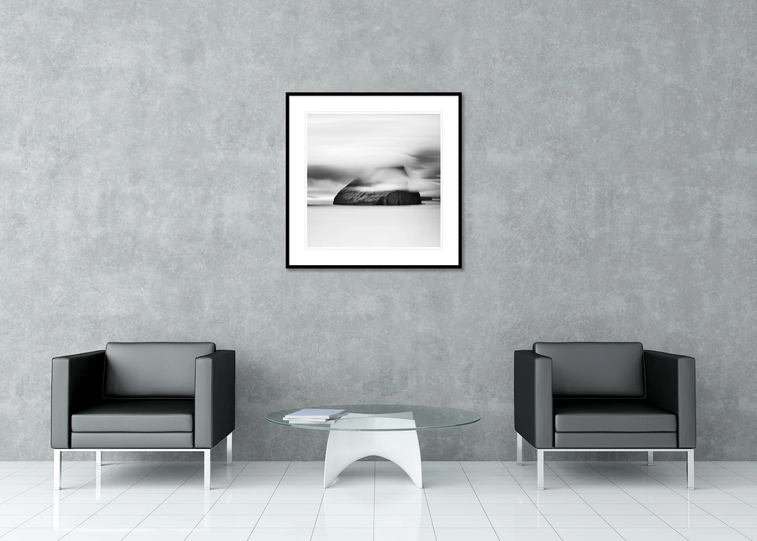 Fine art black and white landscape print of a dramatic sea rock island beneath flowing cloud, archival pigment print in a classic frame with a mount