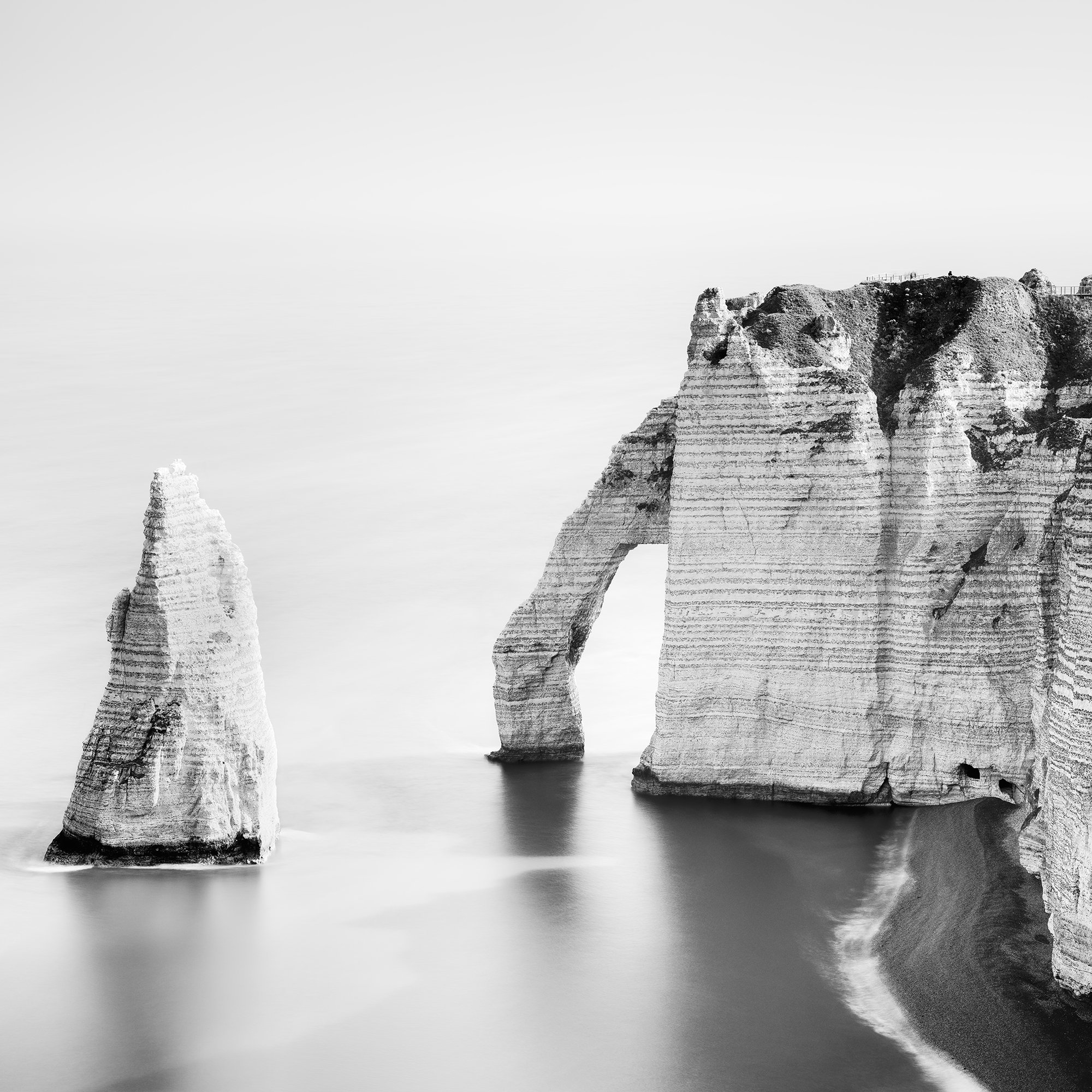 Detail of The Cliffs of Étretat, Study 3 by Gerald Berghammer, highlighting the sculptural limestone formations and sea arch against the pale sky.