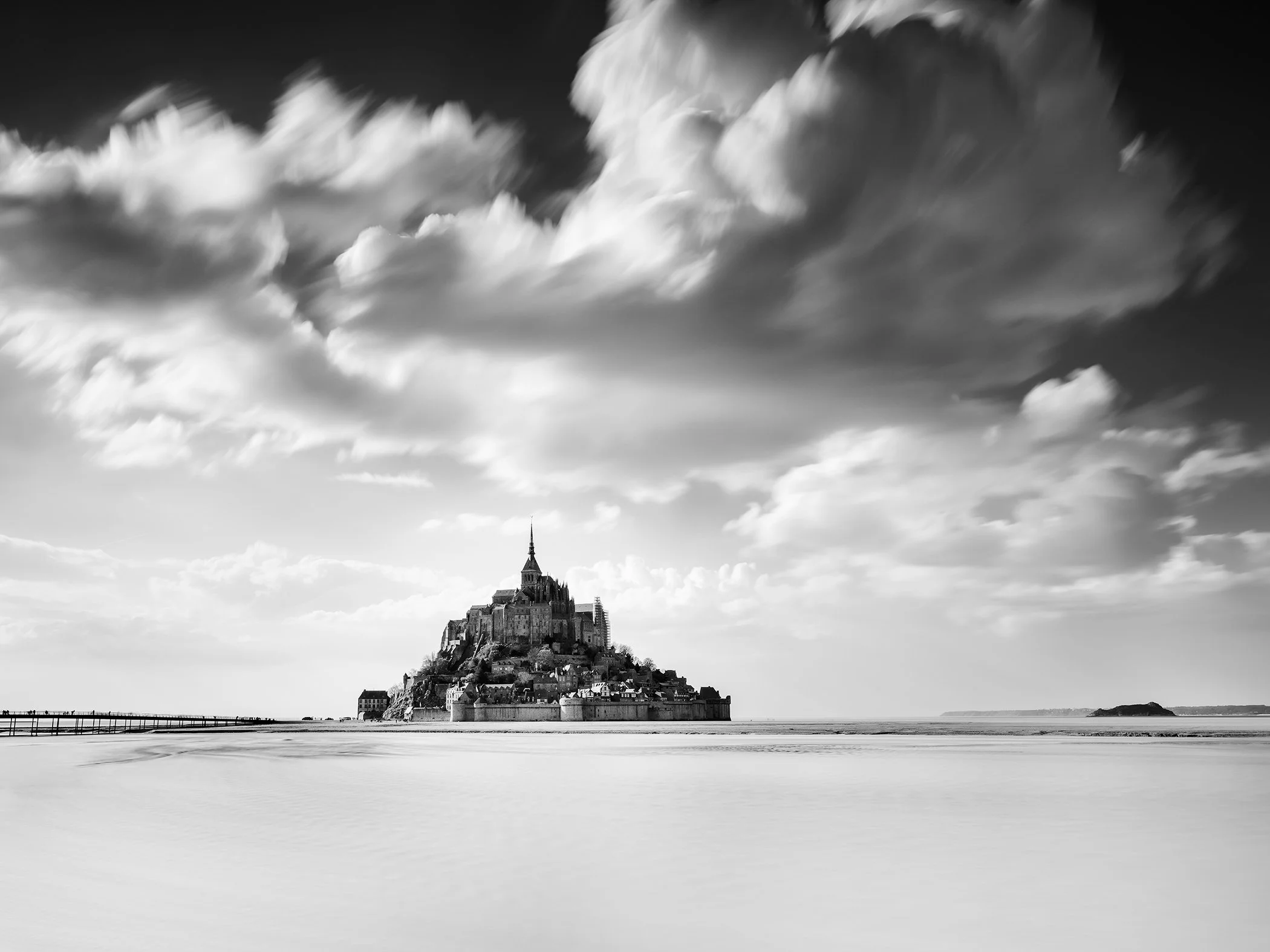 Black-and-white long-exposure photograph of Mont-Saint-Michel in Normandy, France, by Gerald Berghammer.