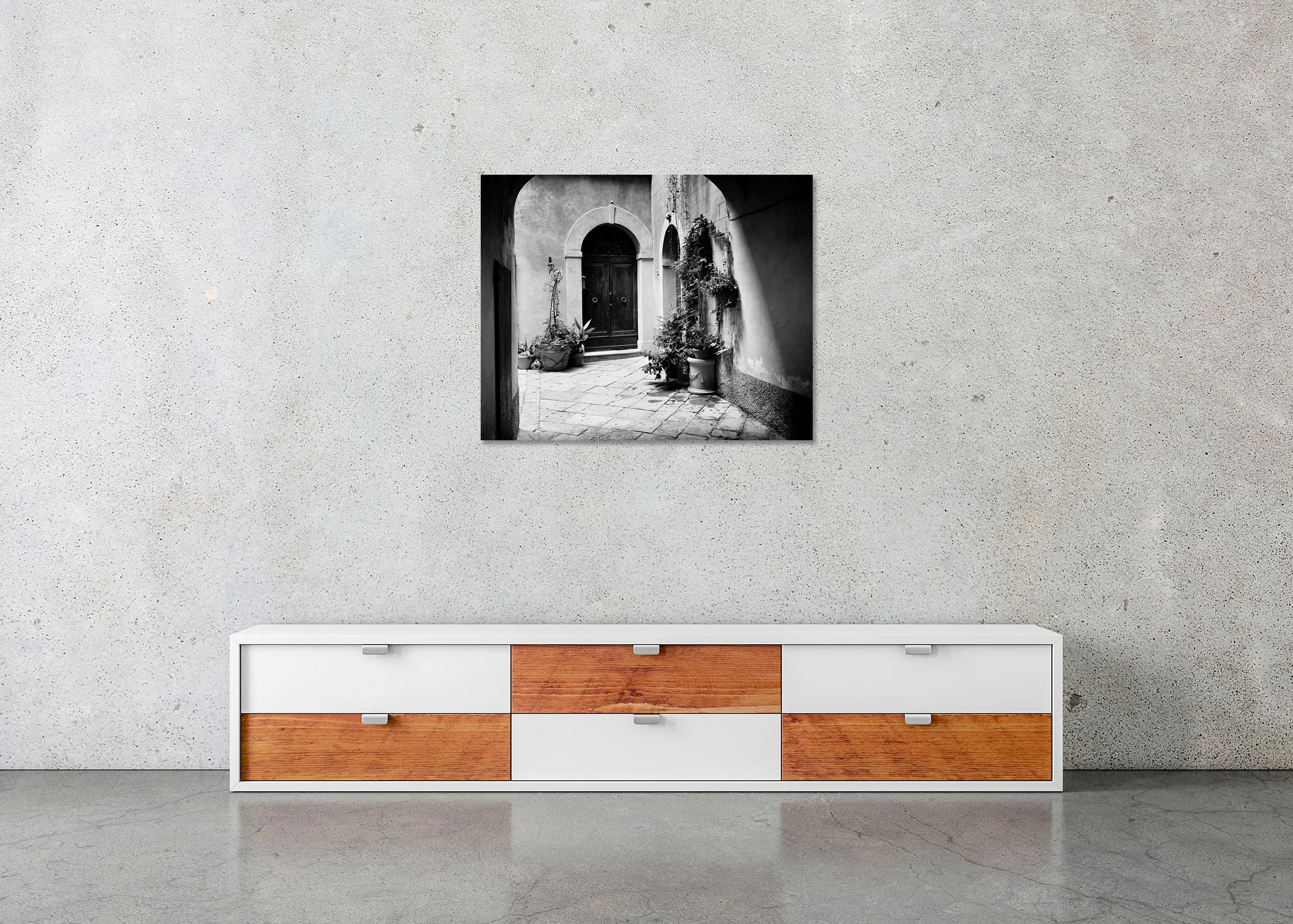 Tuscan Courtyard Study 2 displayed in a modern interior as a frameless black-and-white artwork mounted on aluminium Dibond by Gerald Berghammer.
