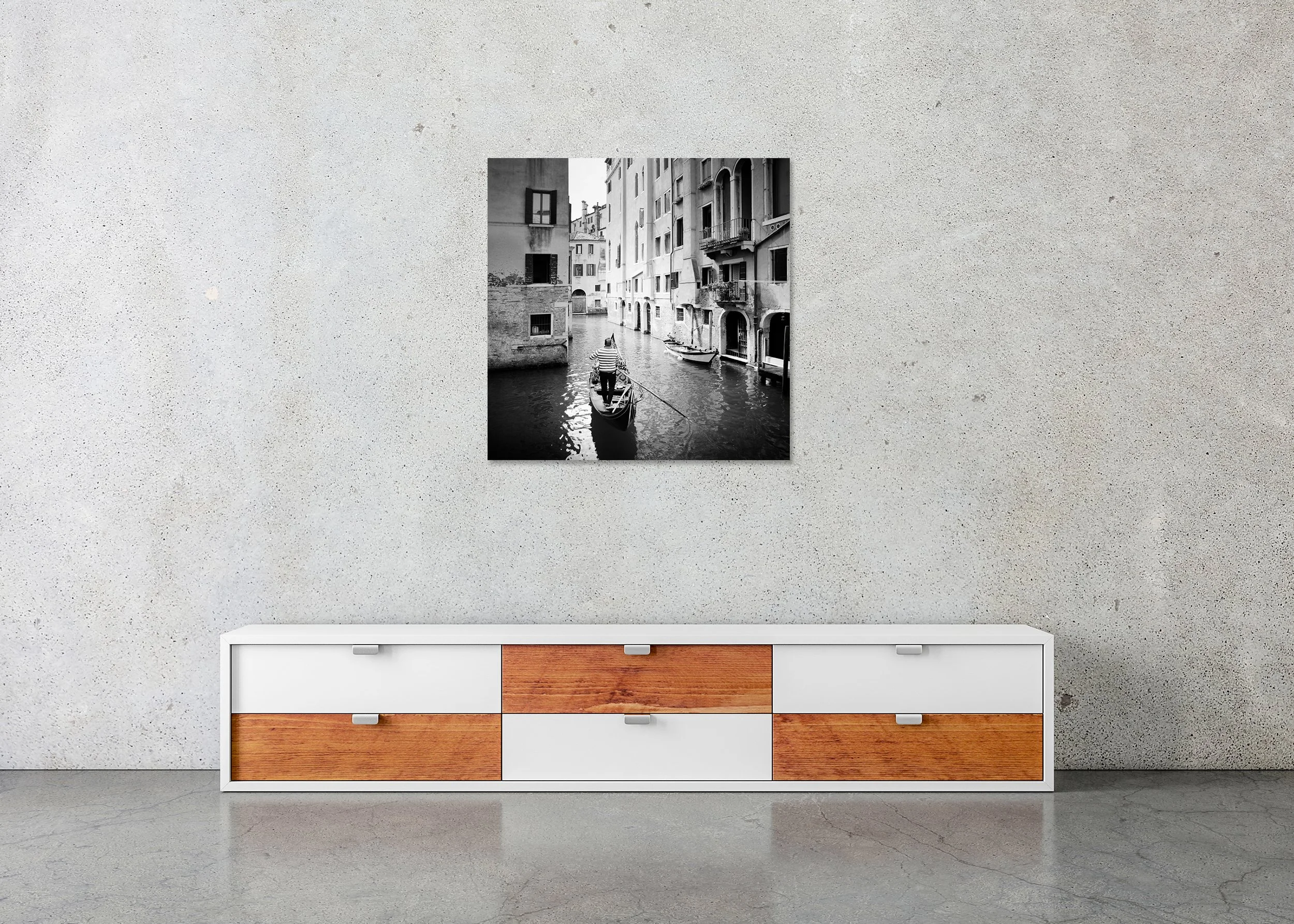 Frameless ChromaLuxe metal print featuring a black-and-white photograph of a gondolier navigating a narrow canal in Venice, Italy, between historic buildings.