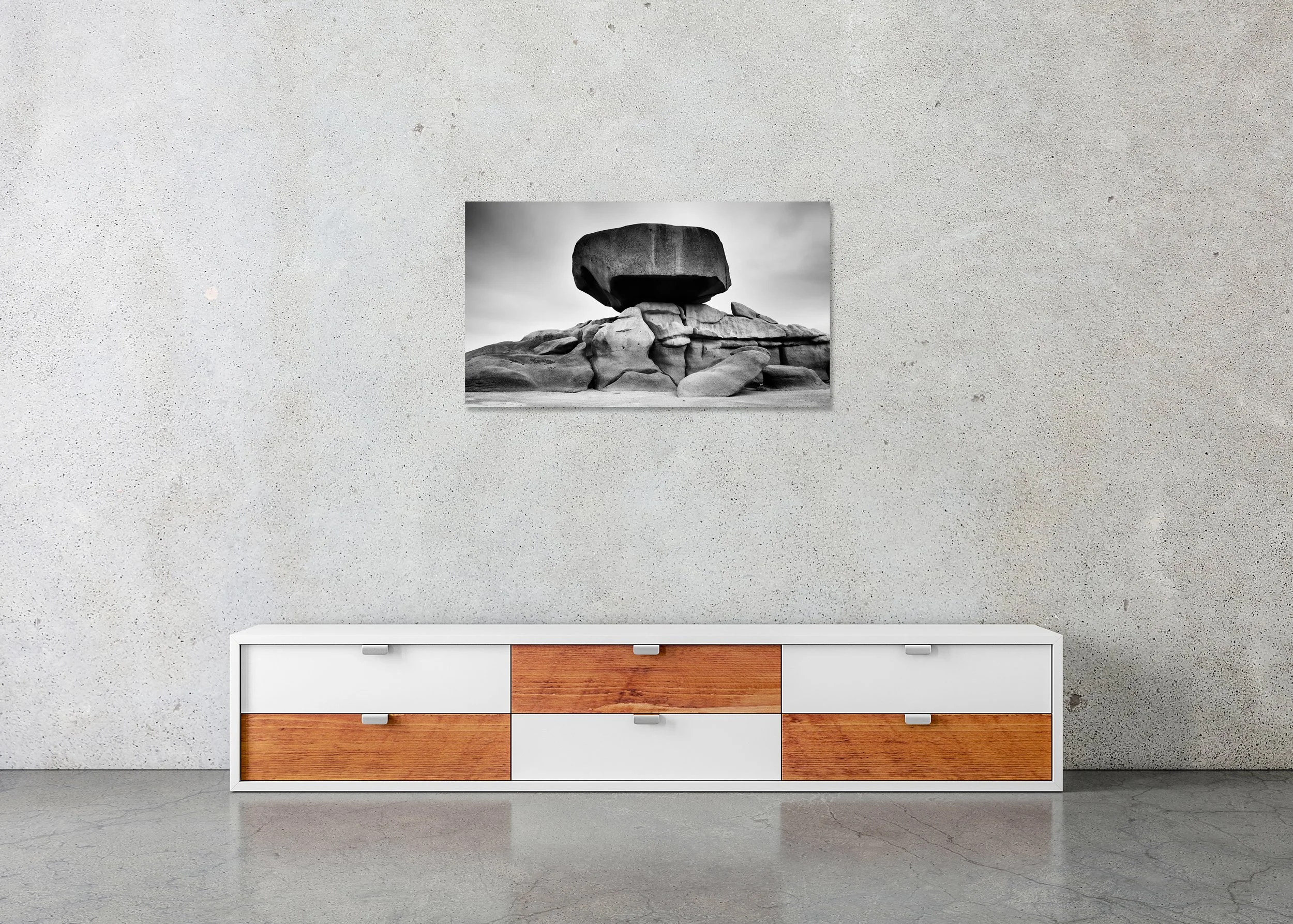 Pink Granite Coast Panorama Study 2 by Gerald Berghammer, frameless black-and-white photograph mounted on aluminium Dibond above a sideboard in a minimalist interior.