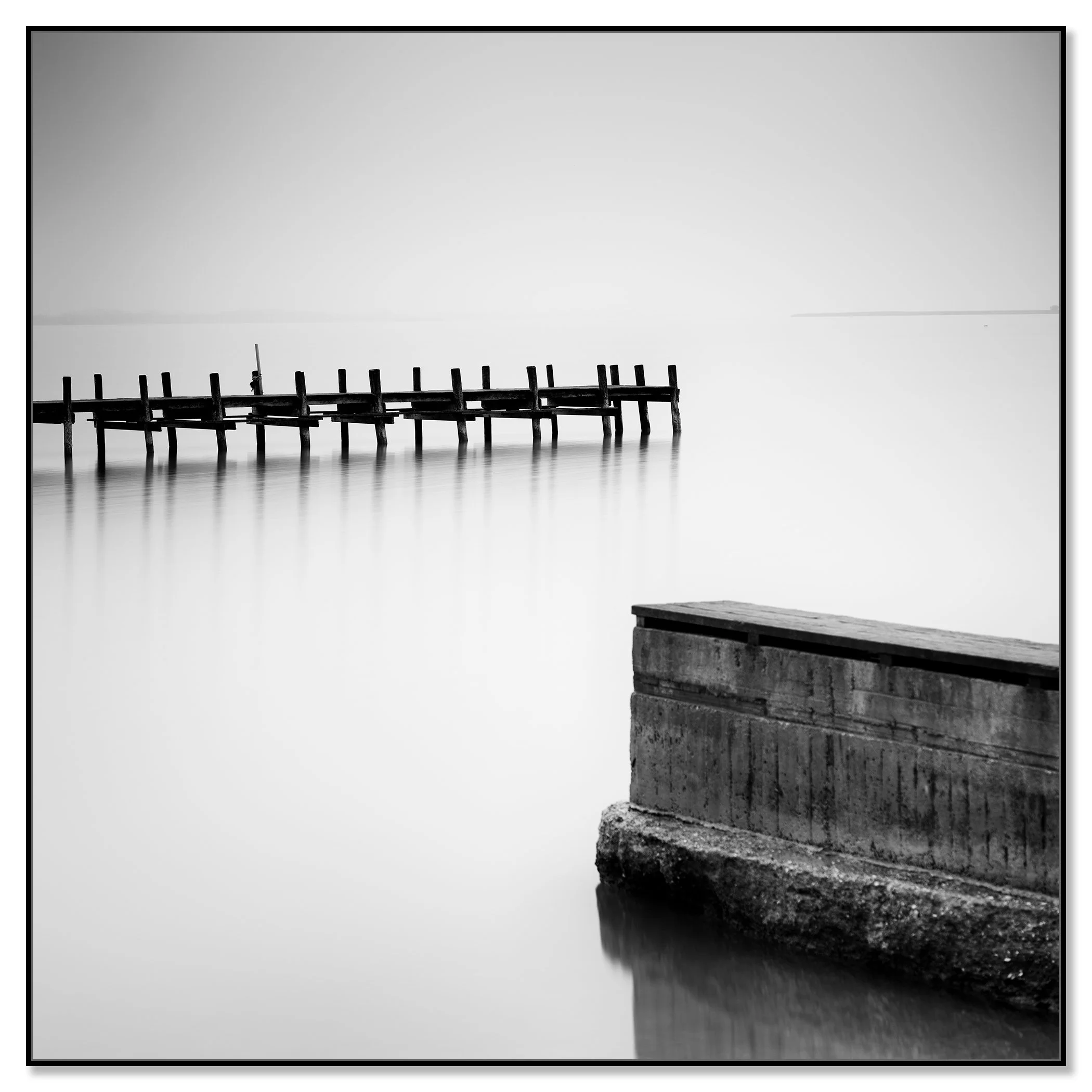 Minimalist black and white image of still water with a deserted wooden dock – framed ArtBox black