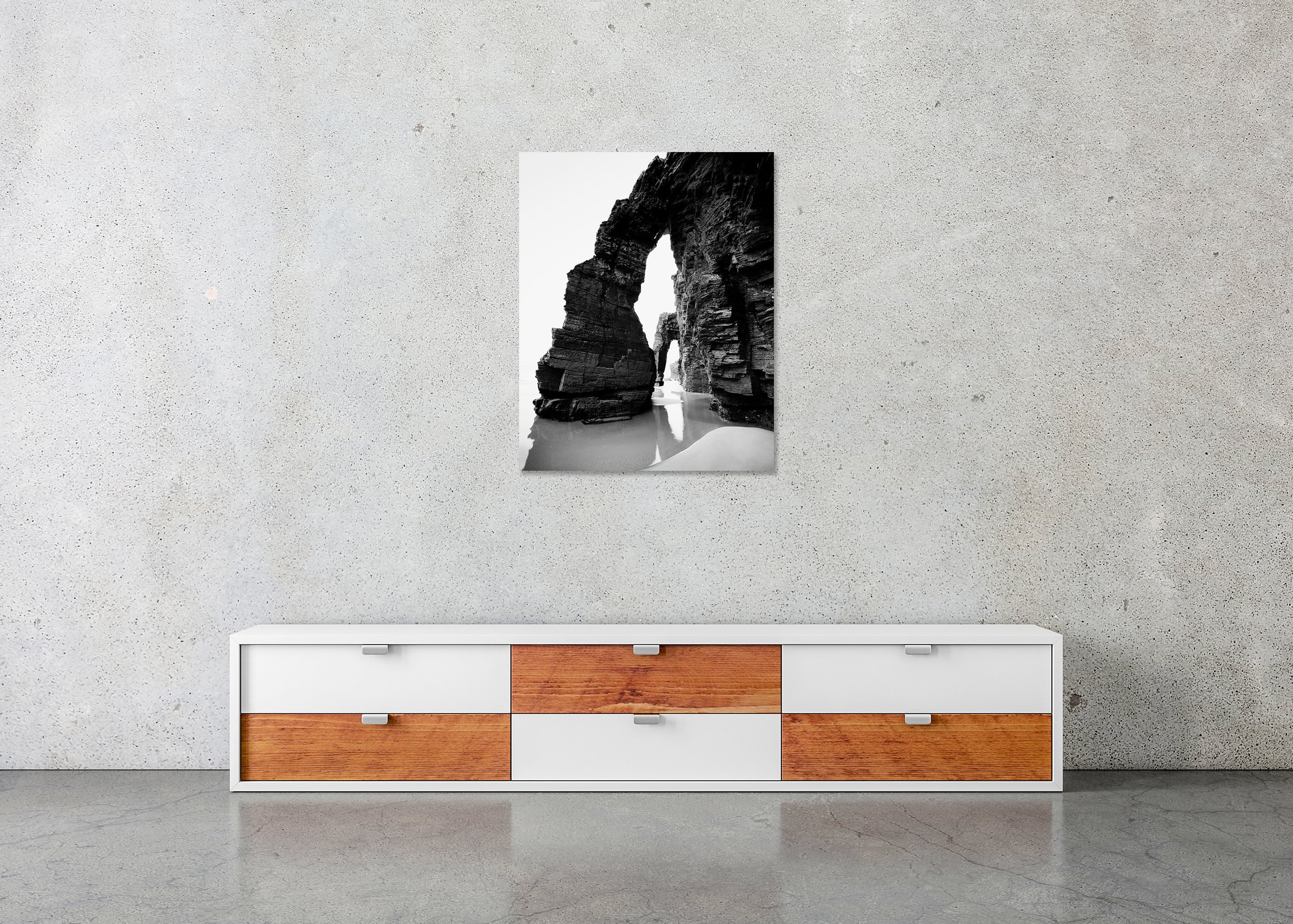 Minimalist black-and-white seascape photo with rock arch, wet sand reflections and soft surf, photo print mounted to Dibond, frameless.