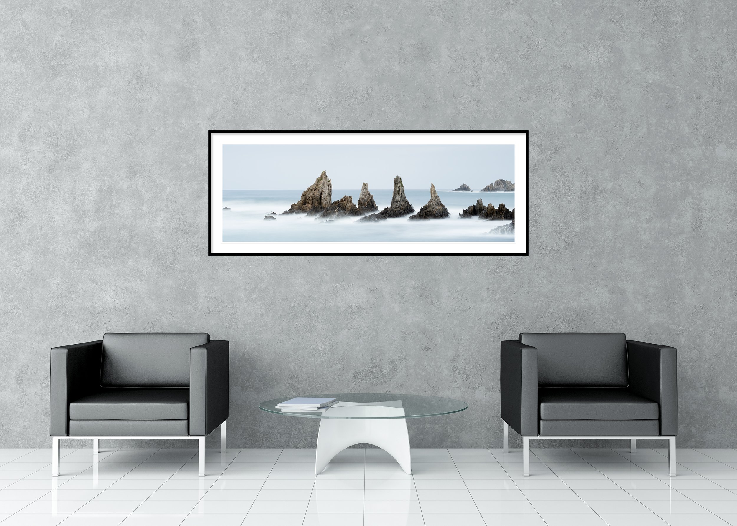 Sea Stack, Study 3 – Bay of Biscay, Spain, archival pigment print in a black aluminium frame with a white mount in a modern lounge.
