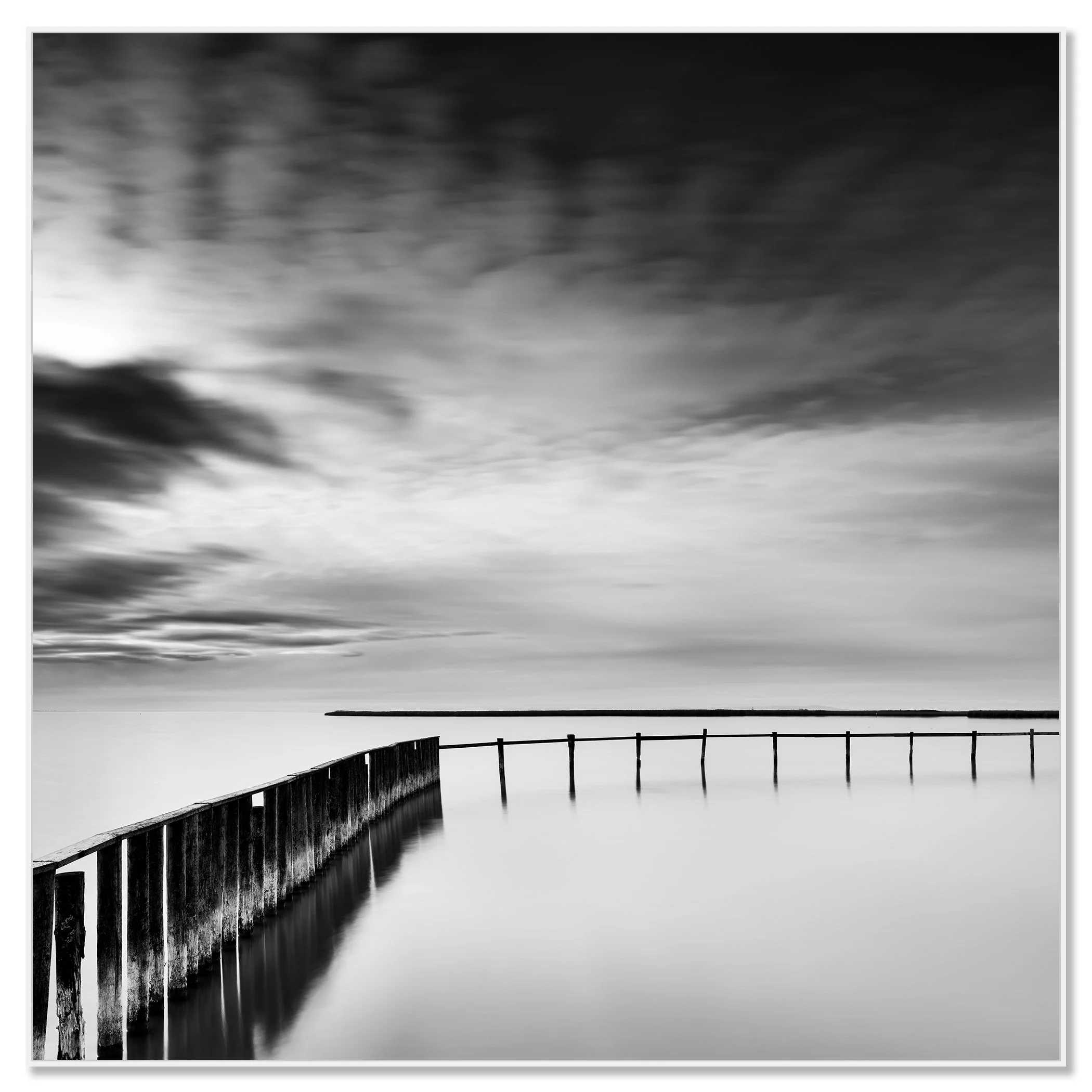 Minimalist black and white landscape with still water and a long wooden jetty – framed ArtBox white