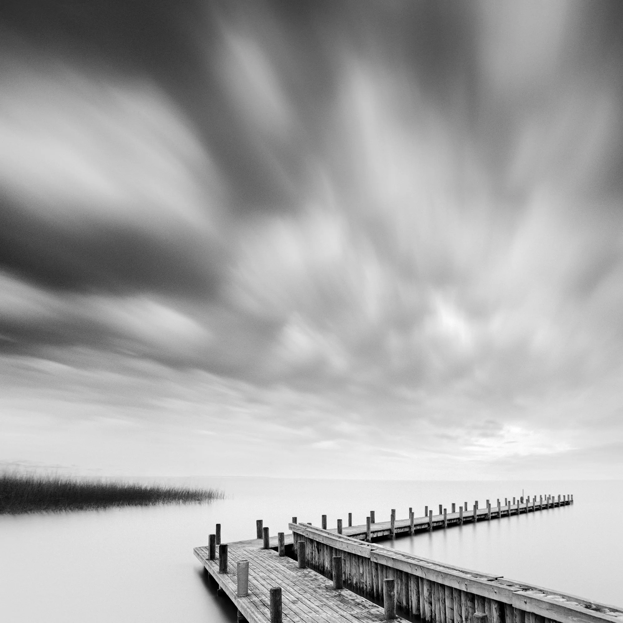 Close-up of Wood Pier Study 1 by Gerald Berghammer, showing weathered timber textures and smooth lake water.