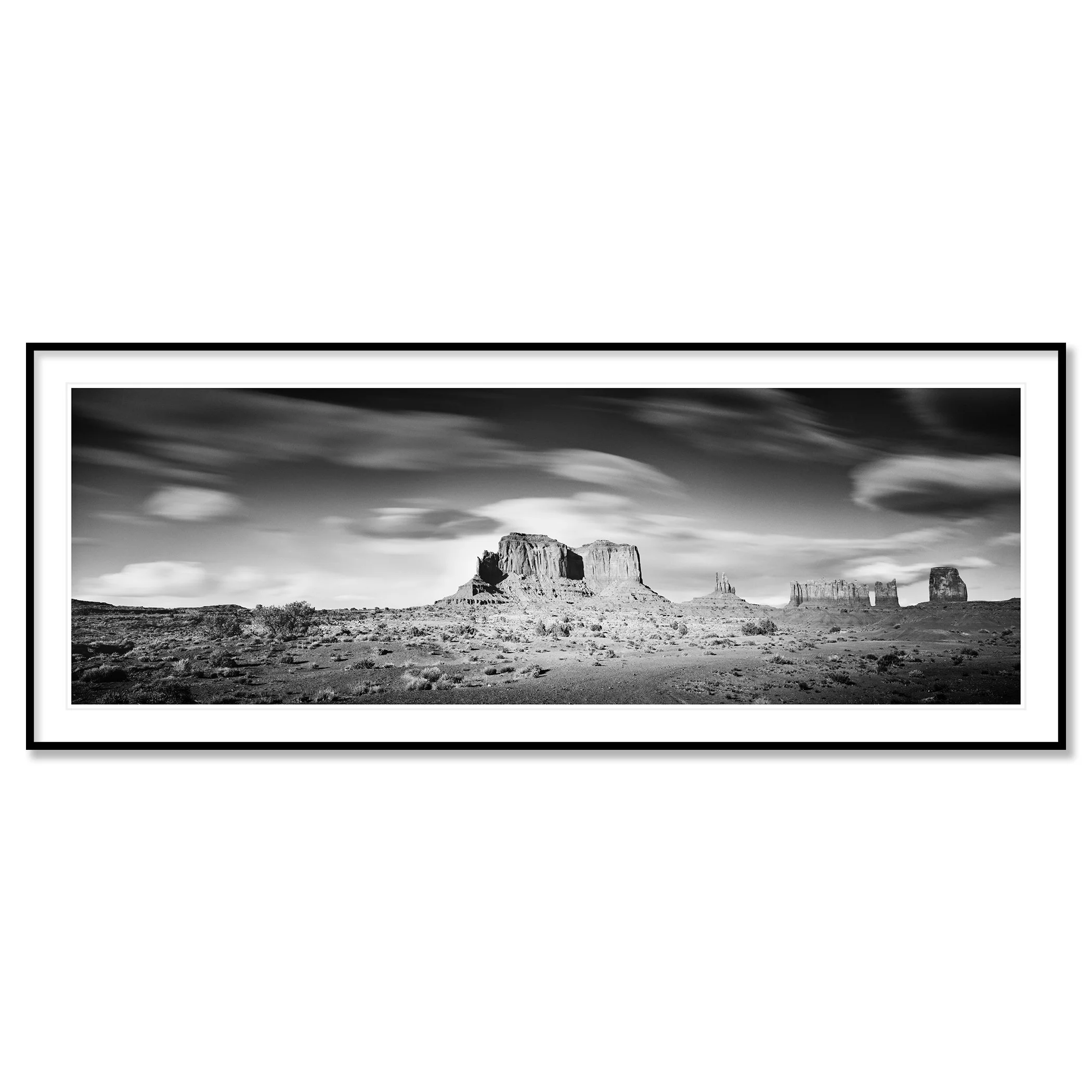 © 2015 Gerald Berghammer - Black and white photography. Landscape of rugged desert terrain with large rock formations and scattered vegetation under a cloudy sky. Classic framed black