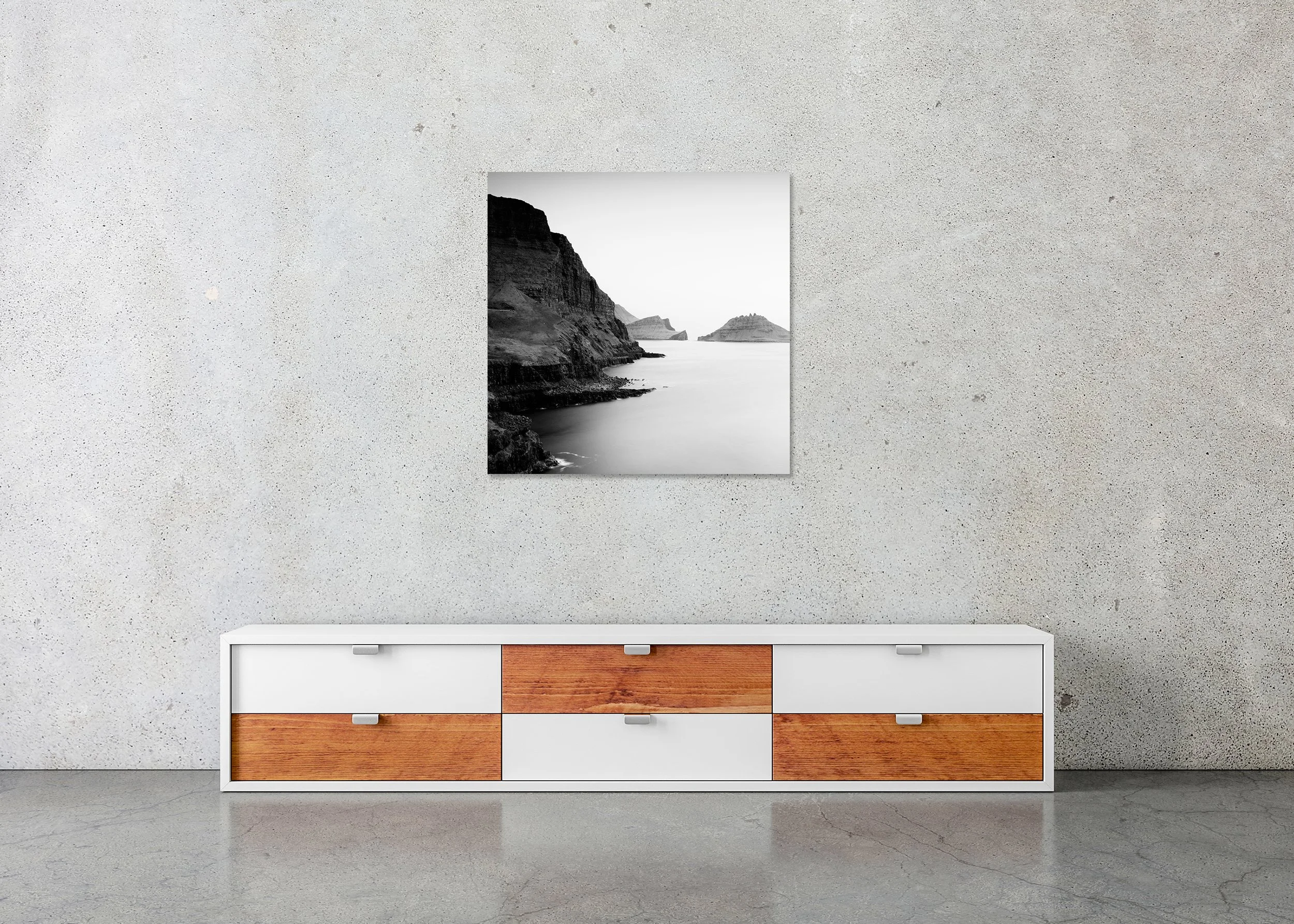 Black and white long exposure of a rocky coastline with towering cliffs and quiet sea, photo print mounted on Dibond, frameless.