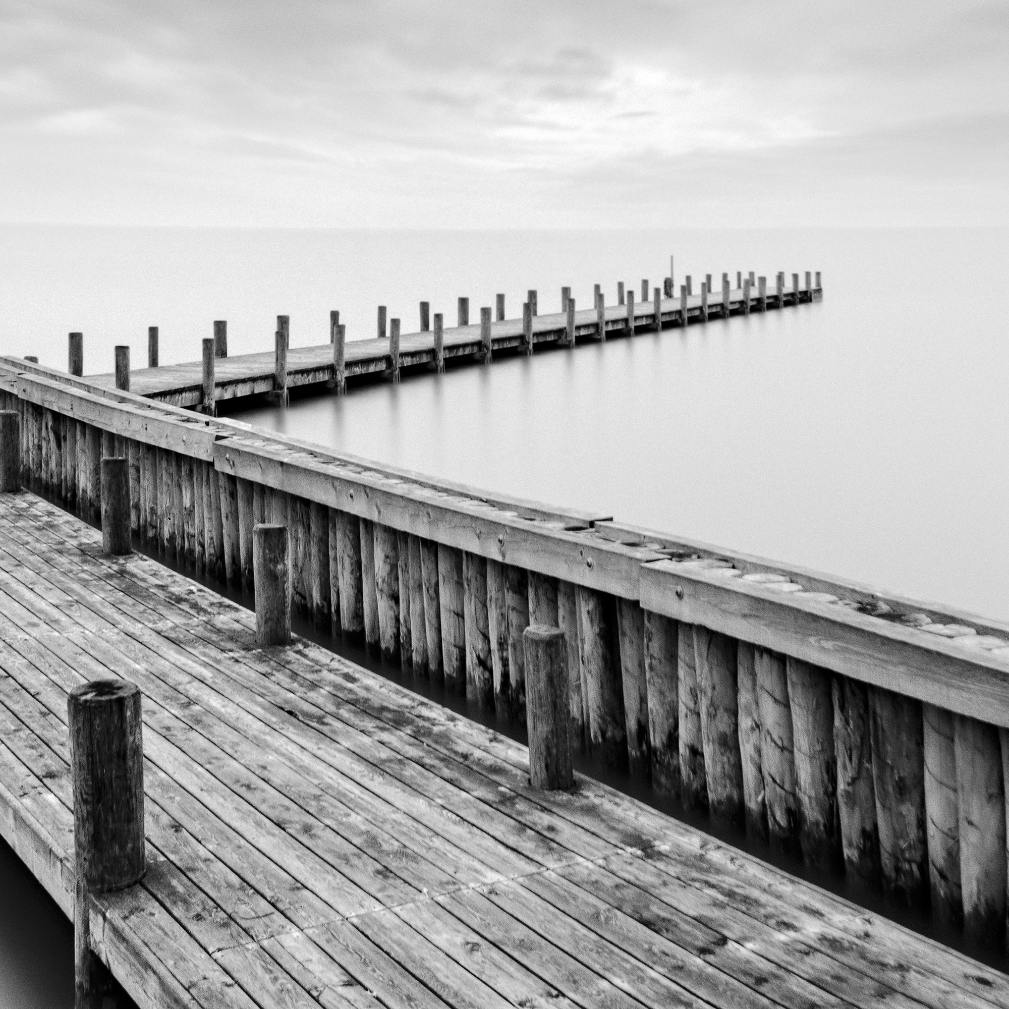 Detail of Wood Pier Study 1 by Gerald Berghammer, showing the wooden pier beneath a dramatic long-exposure sky.