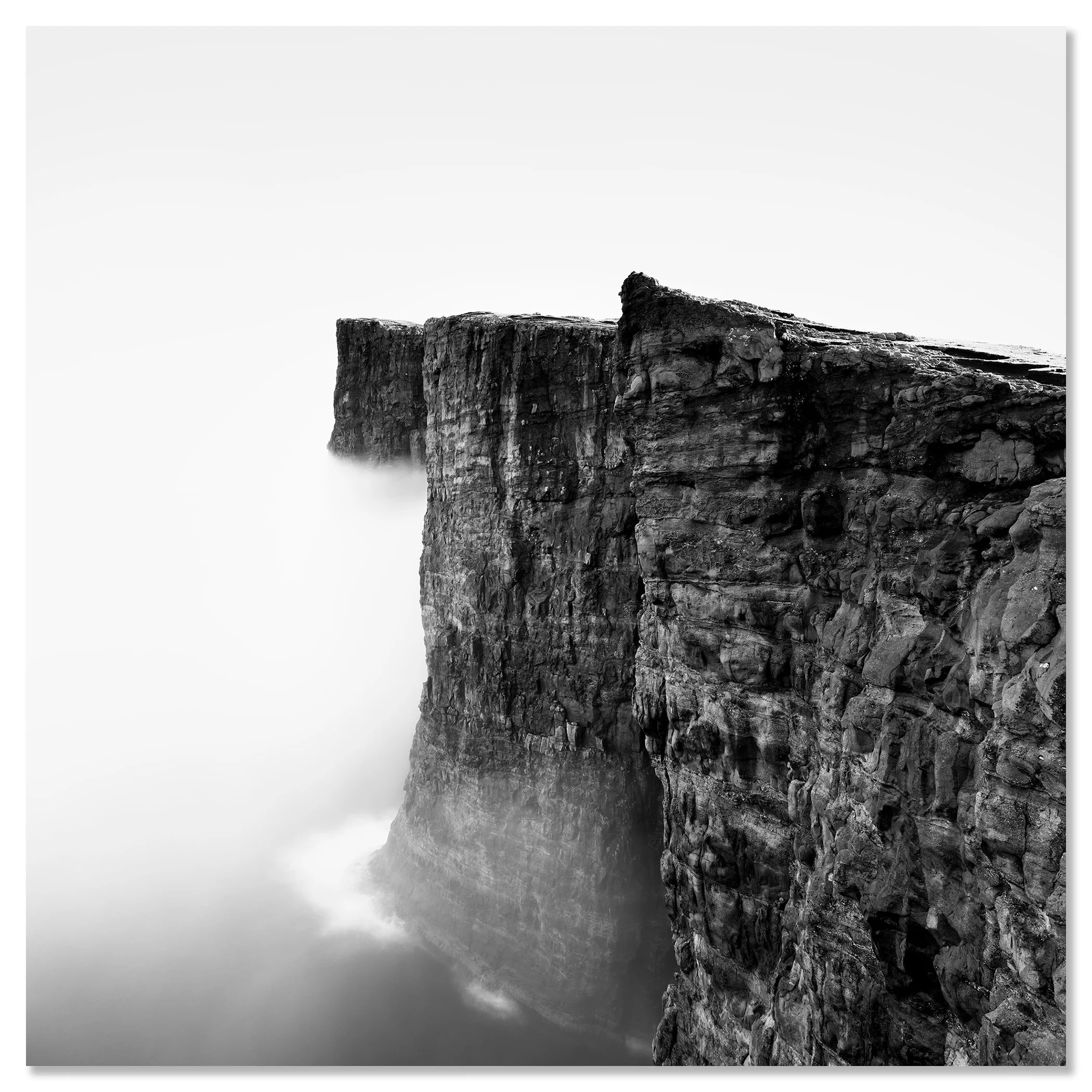 Minimalist black-and-white photo of rugged sea cliffs in mist over the North Atlantic, Faroe Islands – dibond frameless