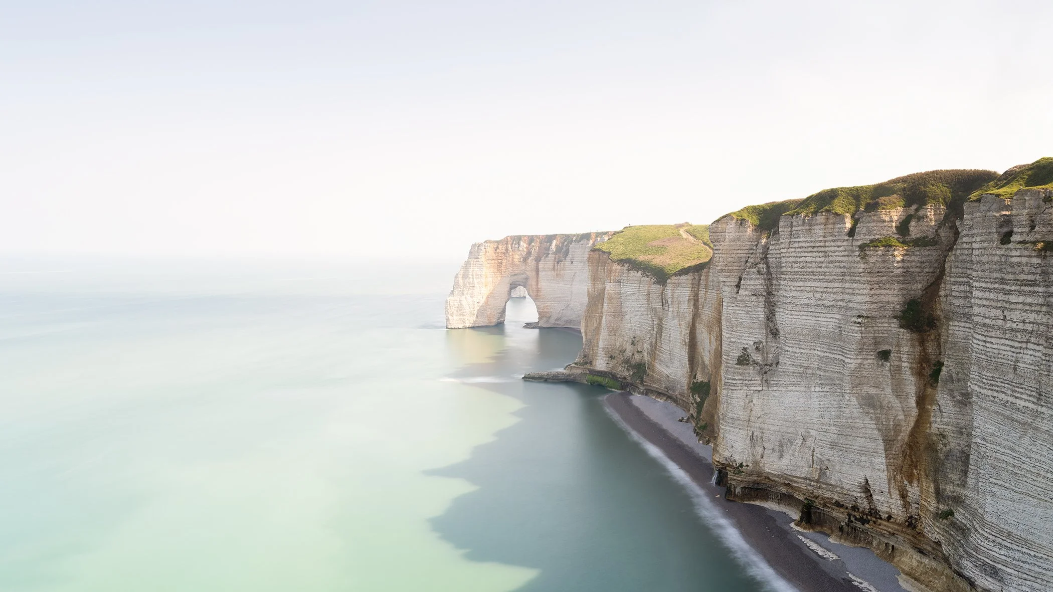 White Cliffs Panorama Study 2 by Gerald Berghammer, colour fine art photograph of the white chalk cliffs and natural sea arch at Étretat, Normandy, France.
