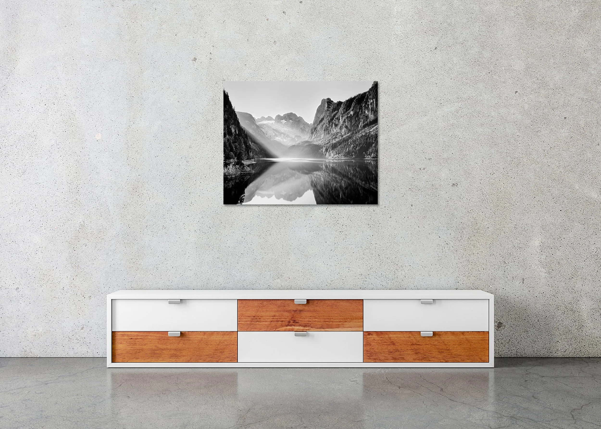 Illumination – Lake Gosau, frameless black-and-white photograph on aluminium Dibond displayed in a minimalist interior. Photo by Gerald Berghammer.