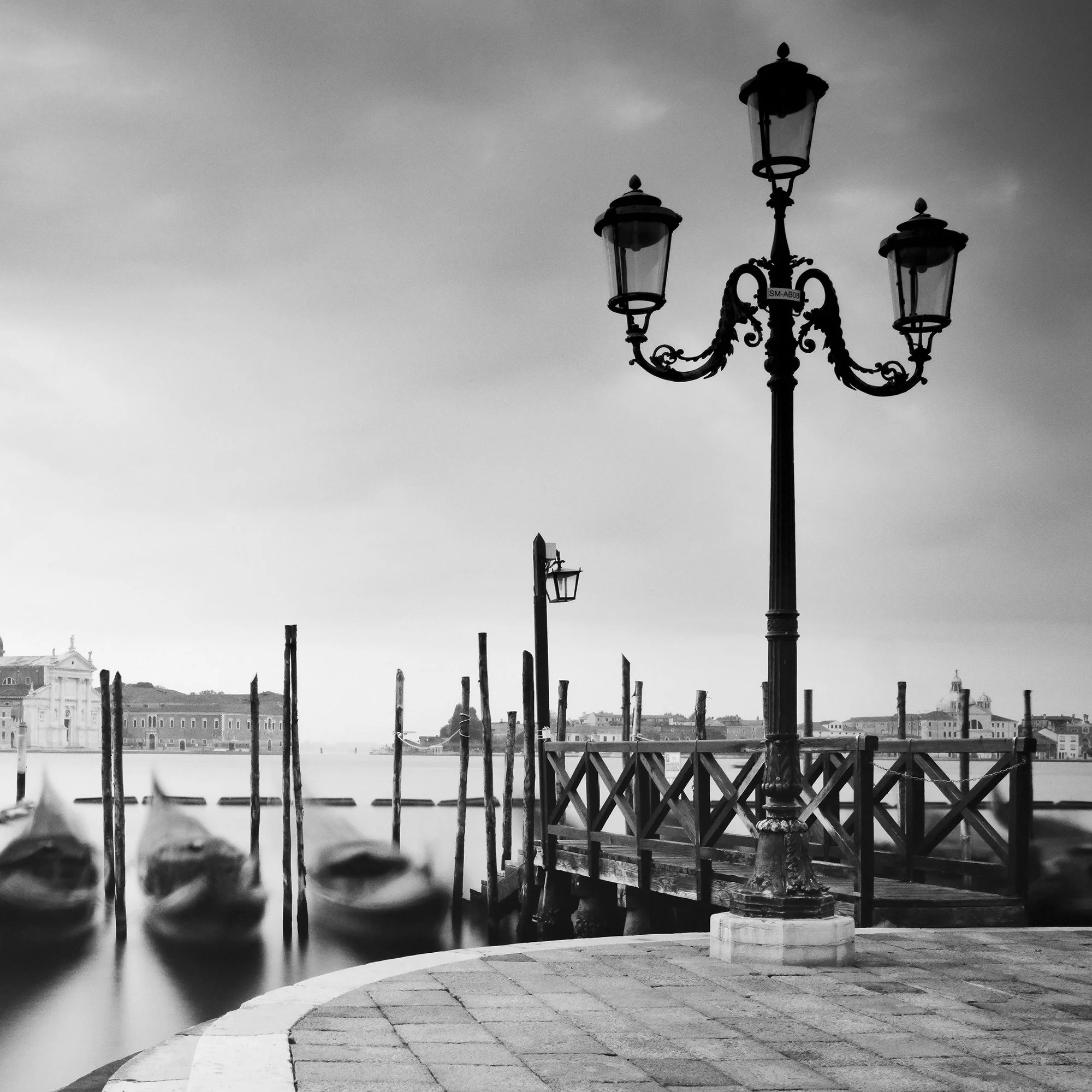 Basilica di San Giorgio Maggiore Study 2 by Gerald Berghammer, detail of an ornate Venetian lamp post, gondolas and waterfront.