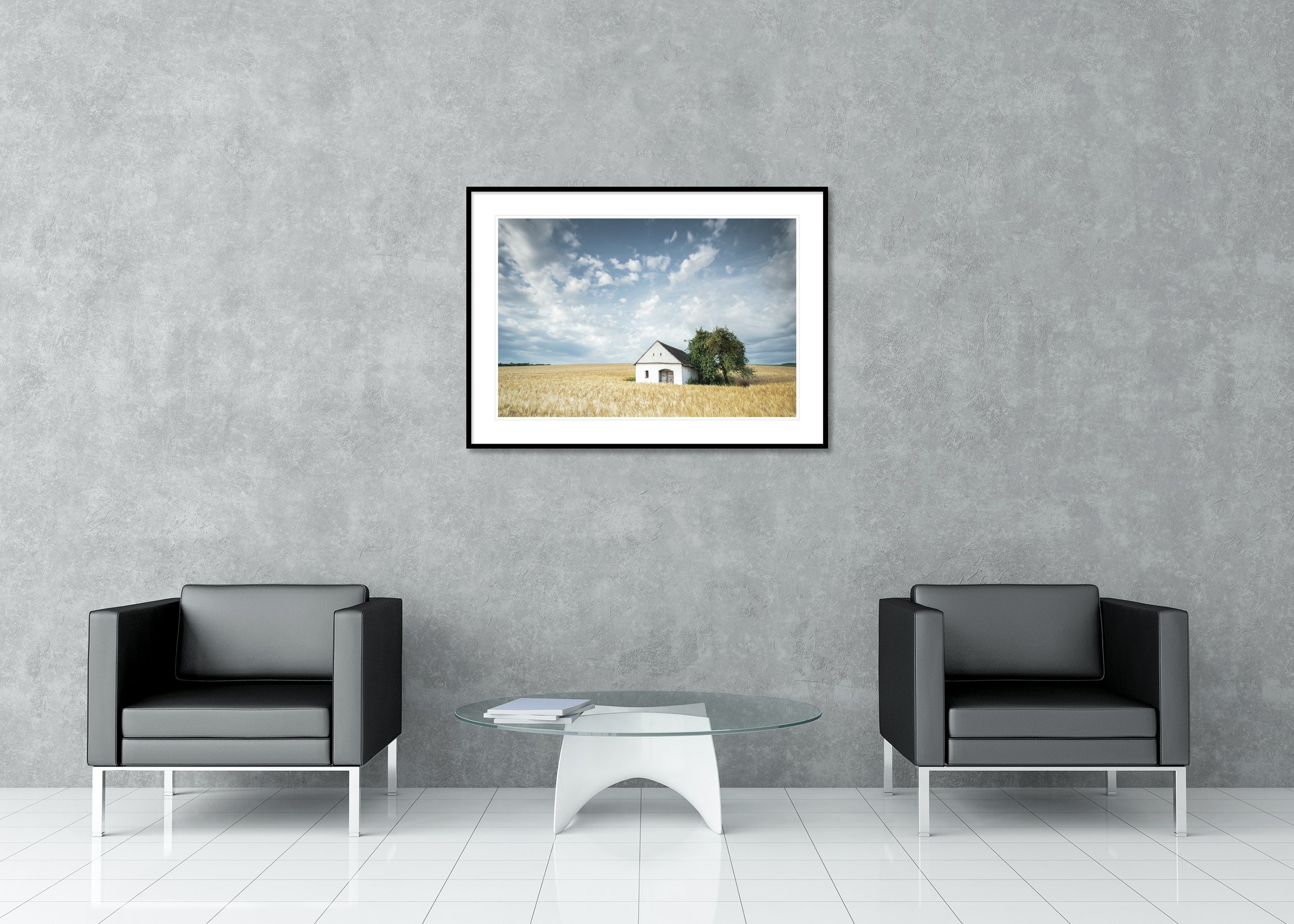 Wine Press House in the Wheat Field displayed in a modern interior as an archival pigment print in a black aluminium frame with white mount by Gerald Berghammer.