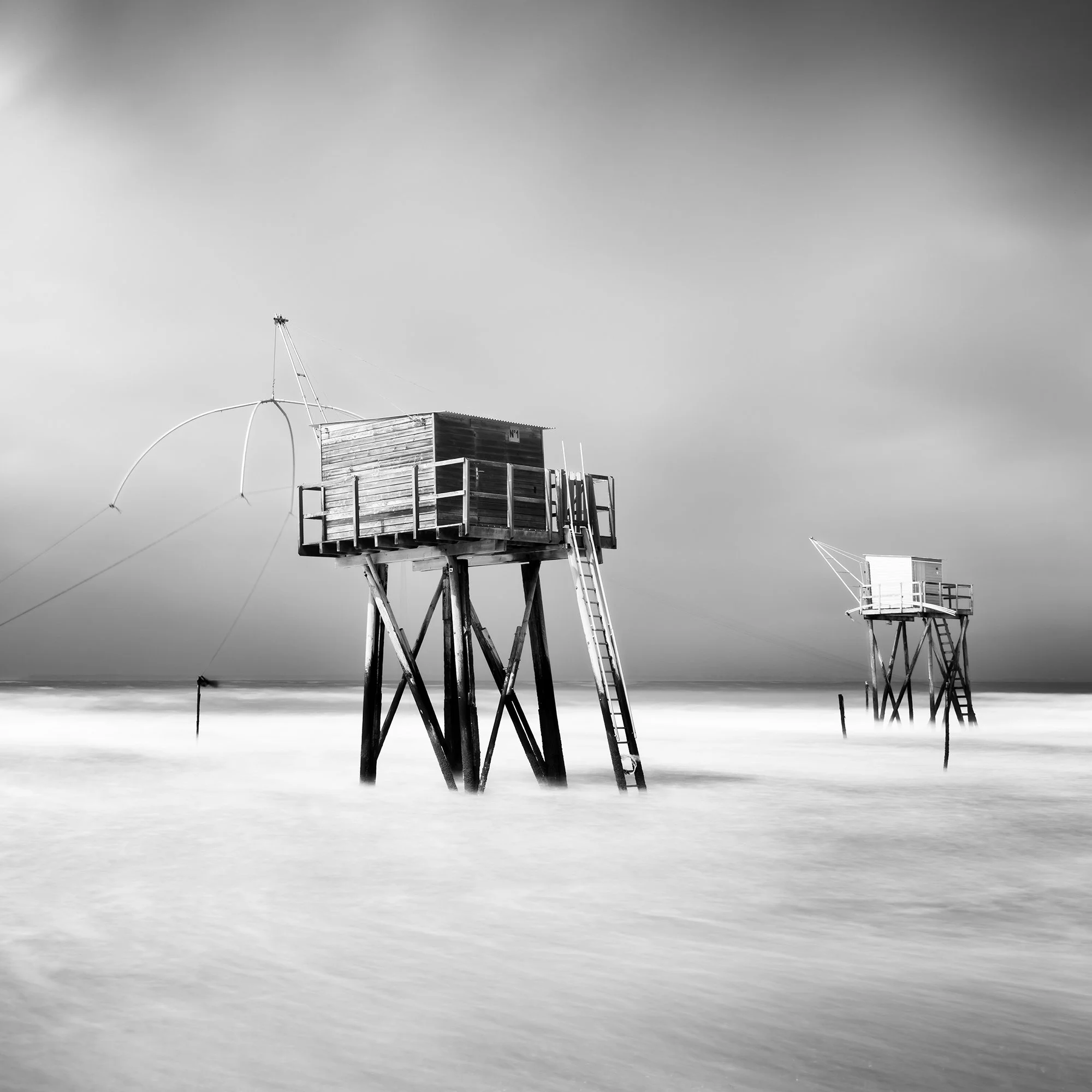 Detail view of Fishing Hut on Stilts Study 4 showing two fishing huts on stilts above the long-exposure sea by Gerald Berghammer.