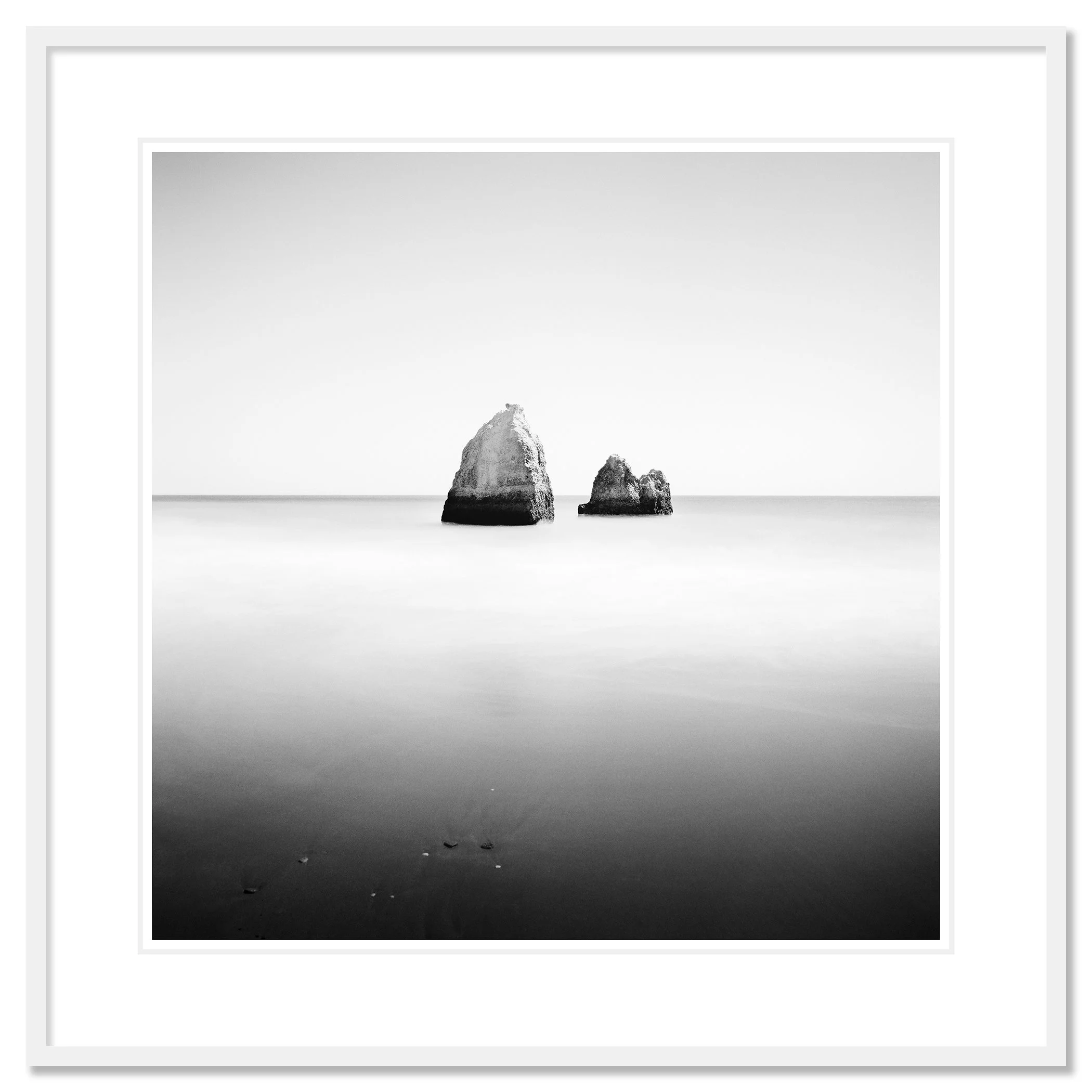 Gerald Berghammer - Long Exposure Seascape Photography. Two large rocks in calm ocean water, black and white photo with minimalistic composition. Classic framed white