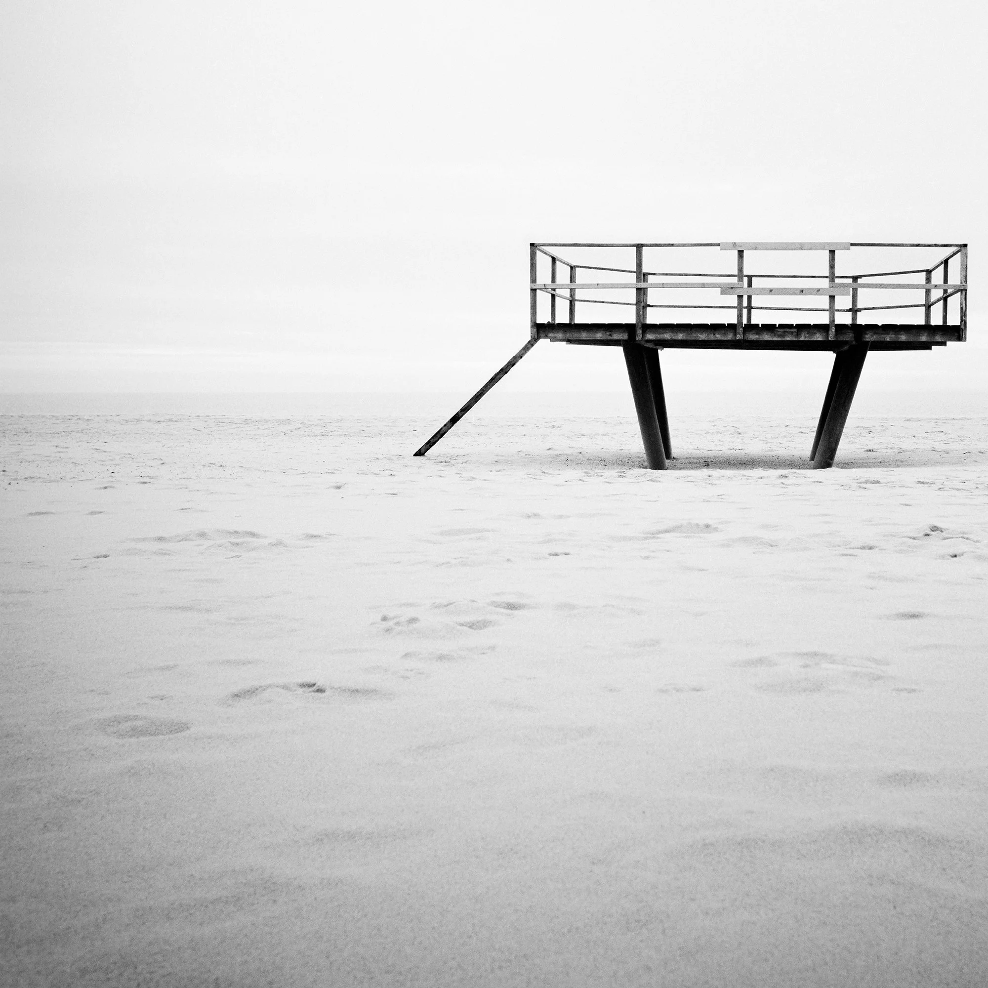 Dance Floor – detailed view of the elevated platform within the minimalist sandy beach landscape of Sylt, Germany, by Gerald Berghammer.