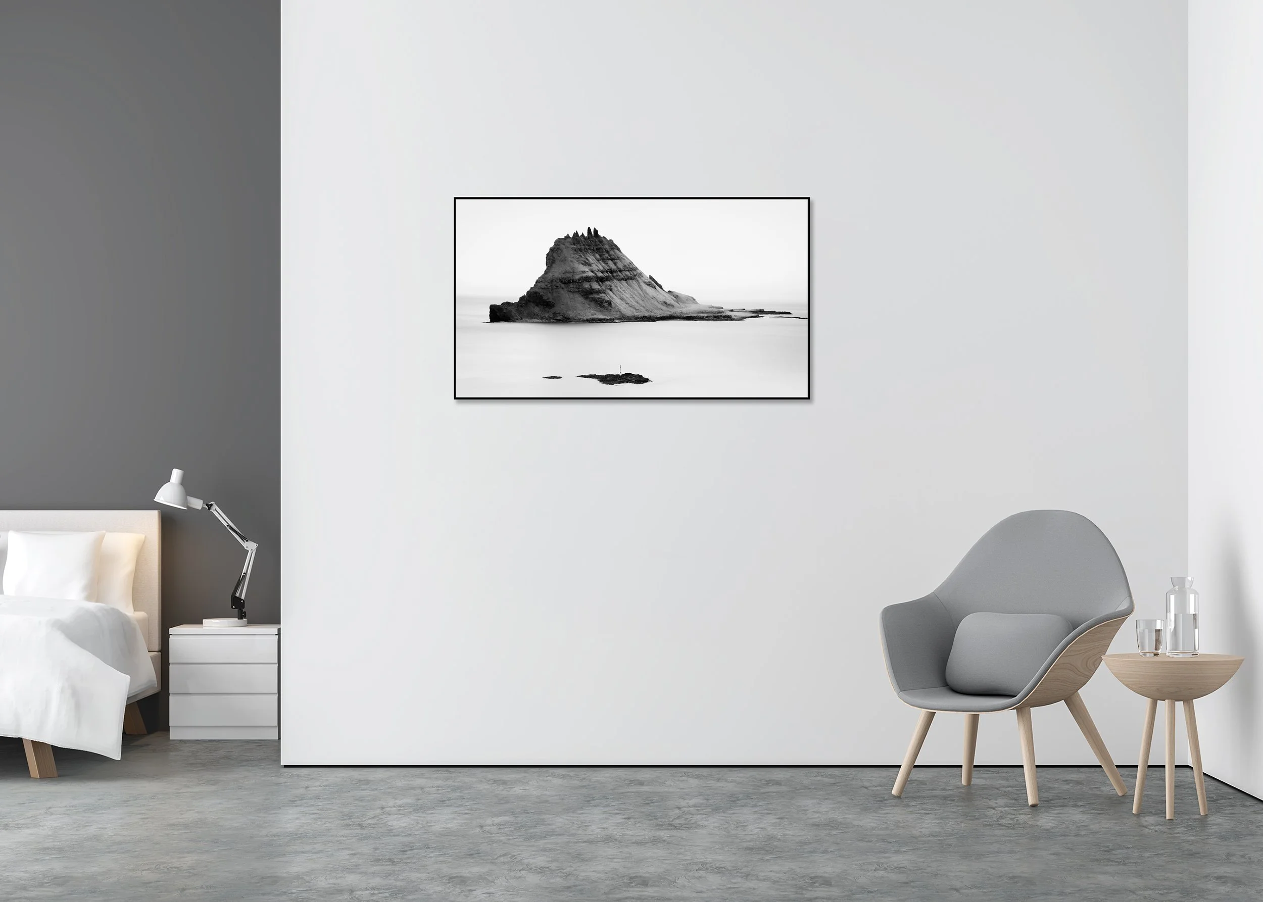 Black-and-white long-exposure photo of a rugged rocky island rising from a calm sea beneath a minimalist sky, printed on ChromaLuxe metal in an Aluminium ArtBox frame.