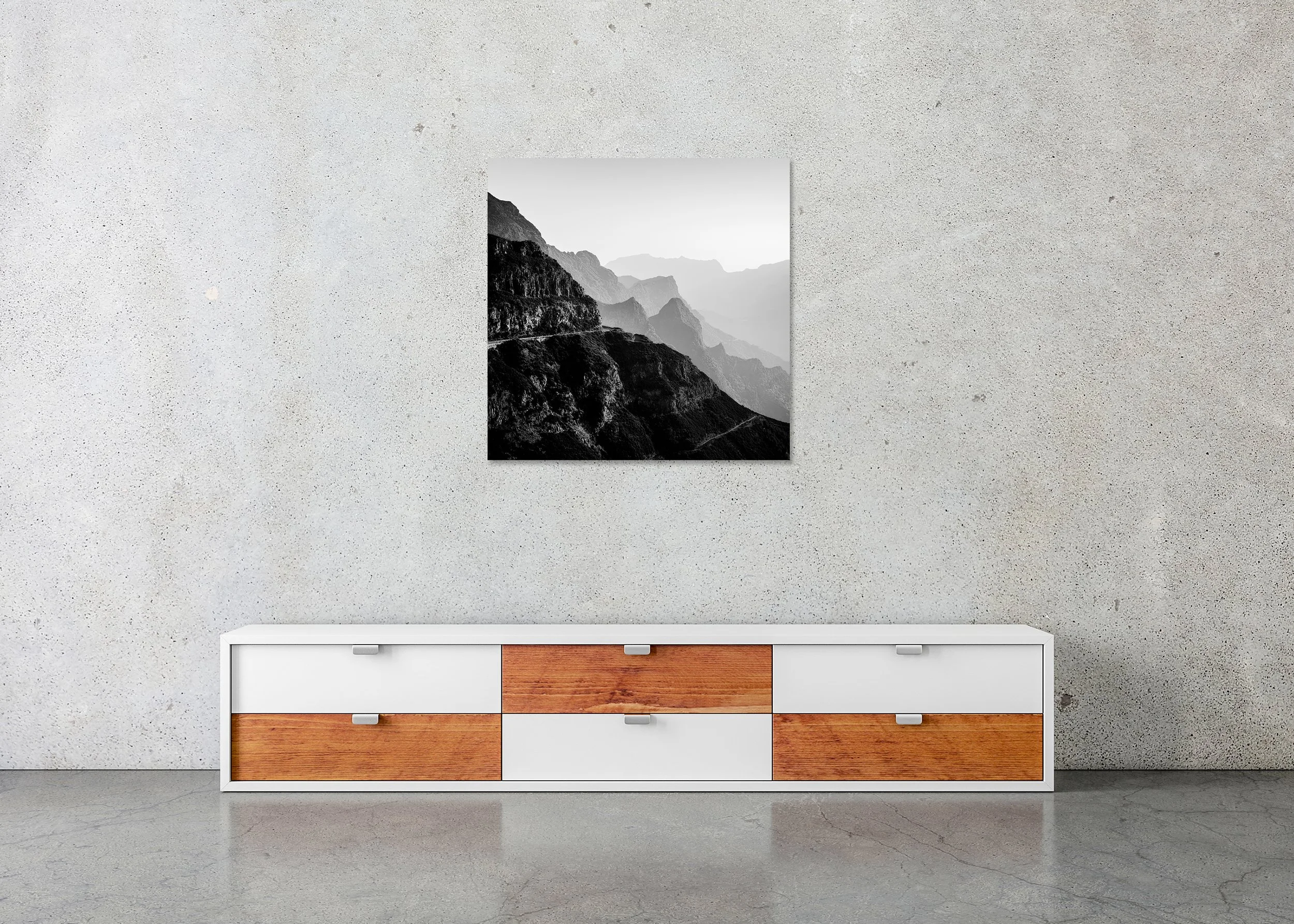 Black and white photo of dramatic mountain slopes and a curving road cutting across the terrain, presented as a frameless ChromaLuxe metal print.
