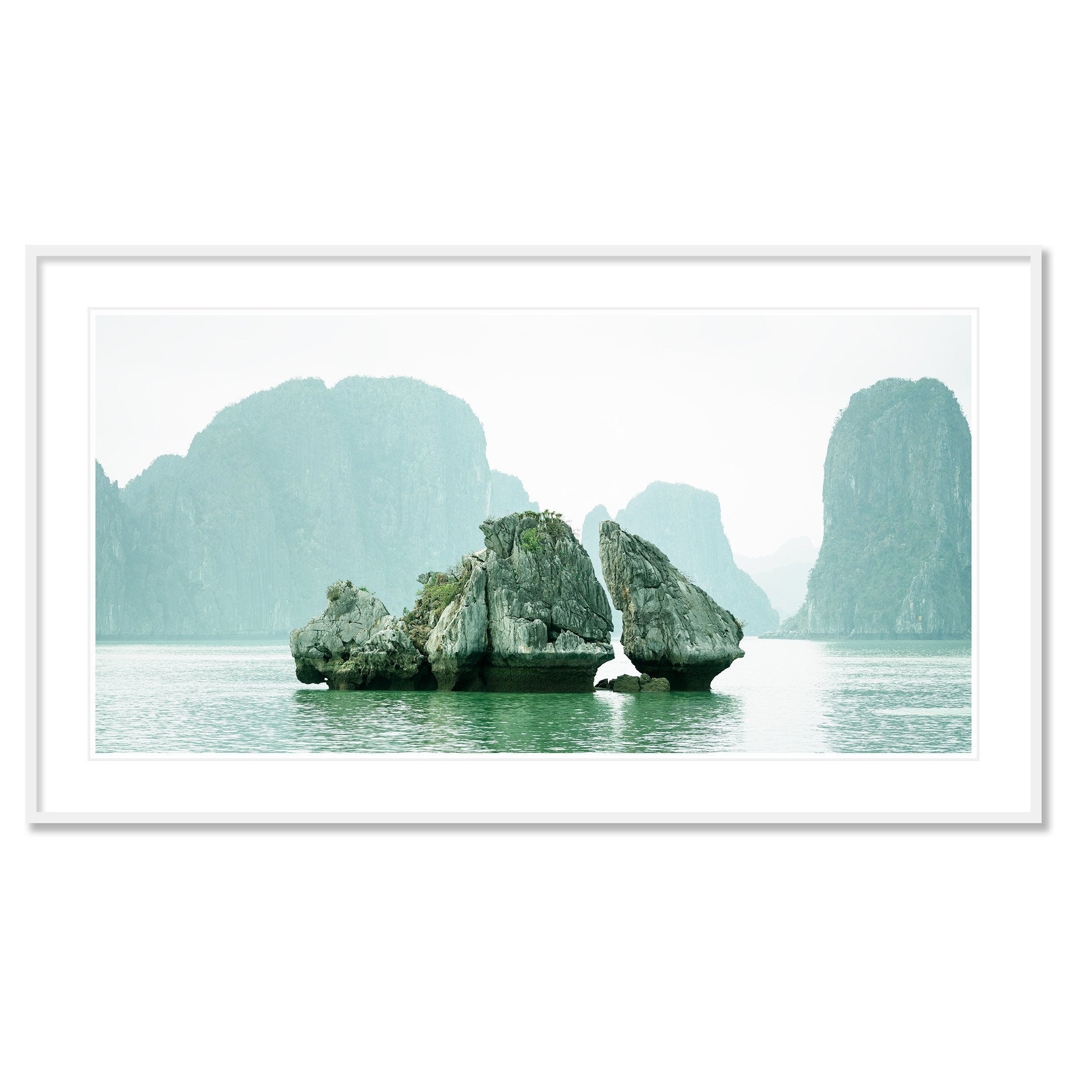 Gerald Berghammer - Color seascape photography. Large rocks rising from the water with, surrounded by calm water and distant limestone cliffs and islands. Classic framed white